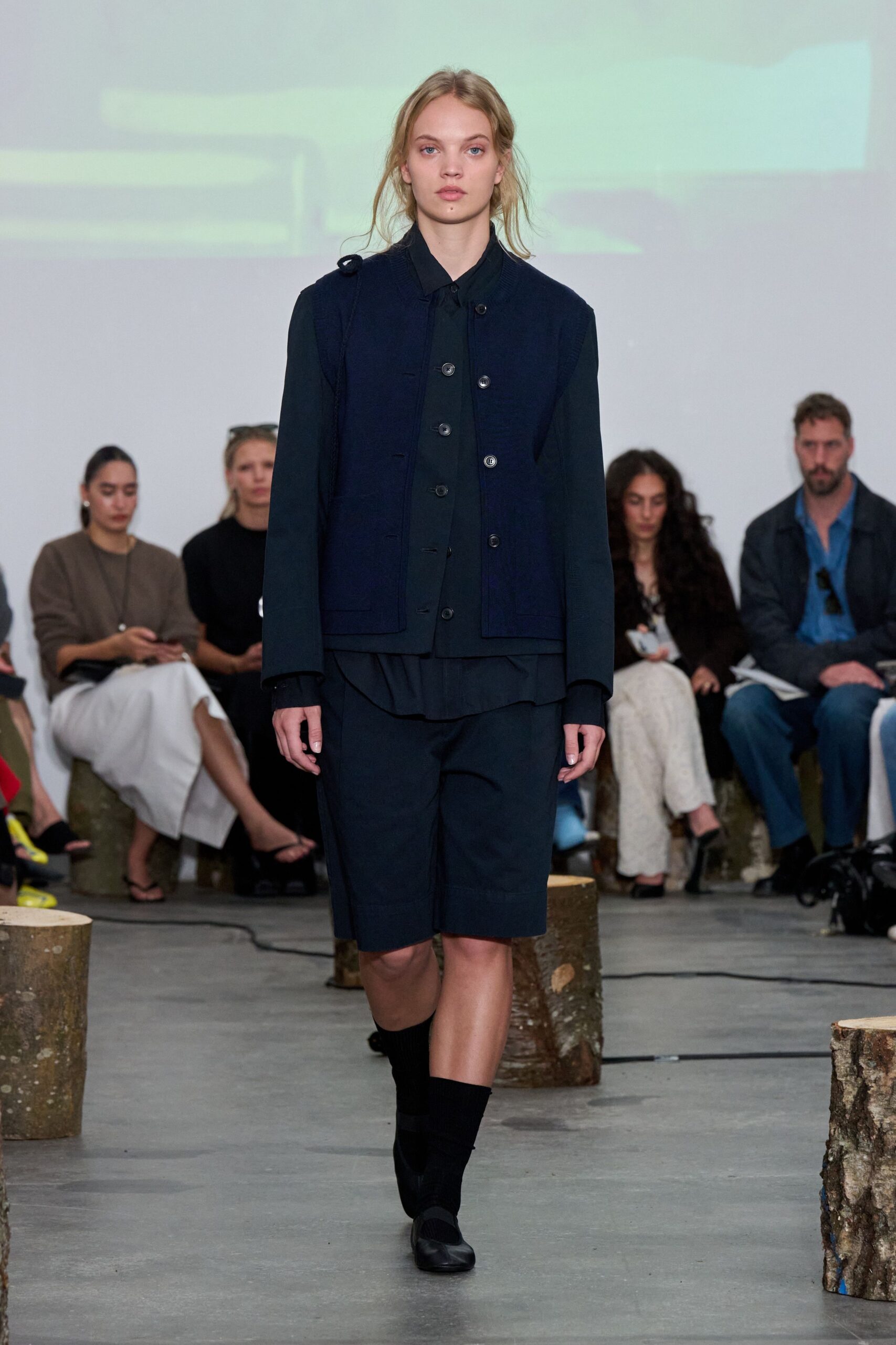 navy jacket black shirt relaxed shorts