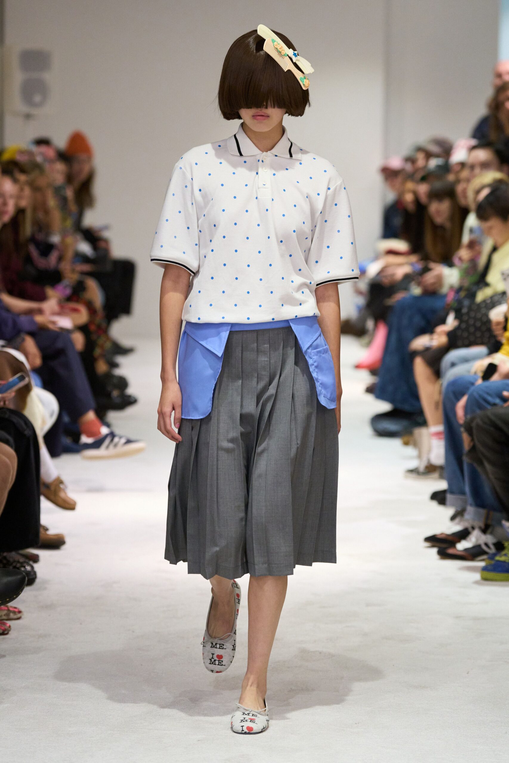 white polka-dot shirt with gray pleated skirt