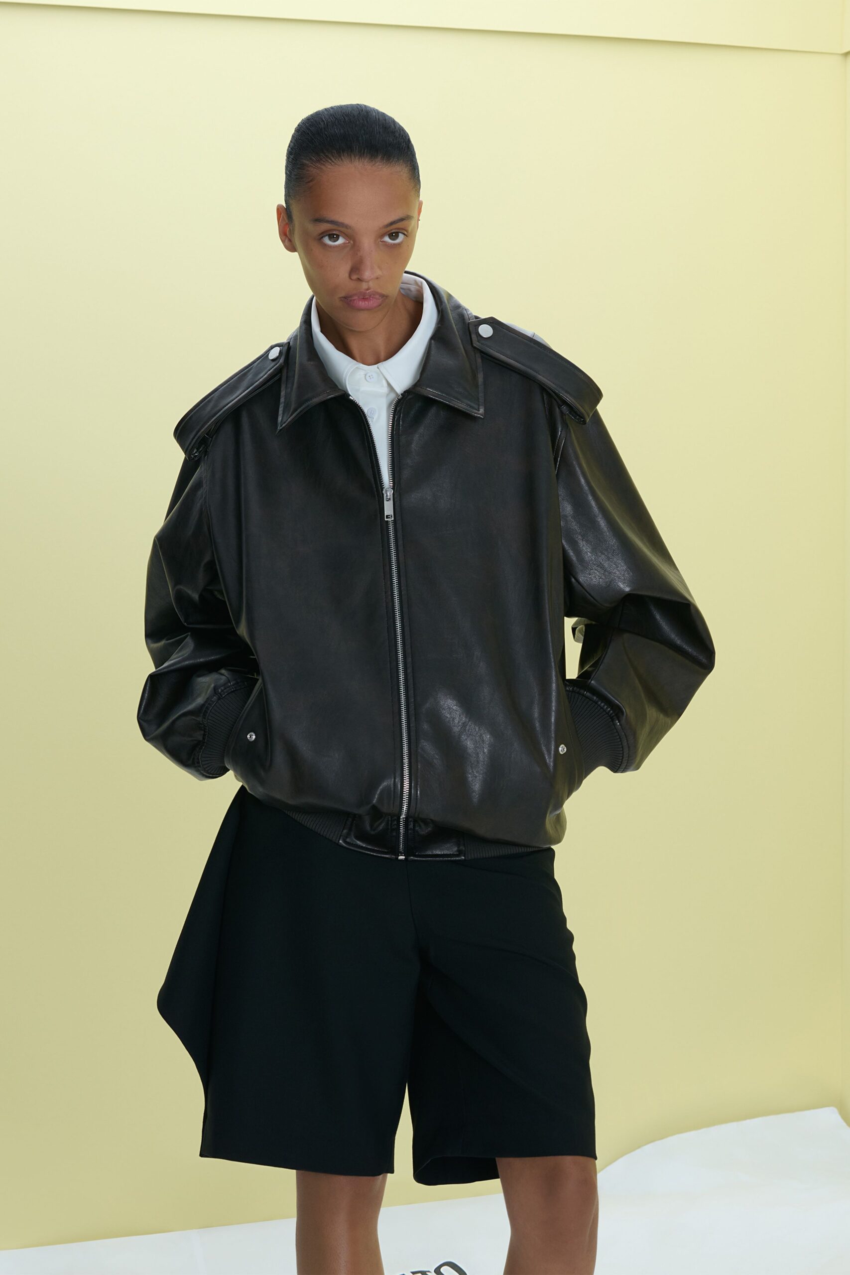 black leather oversized jacket and black shorts