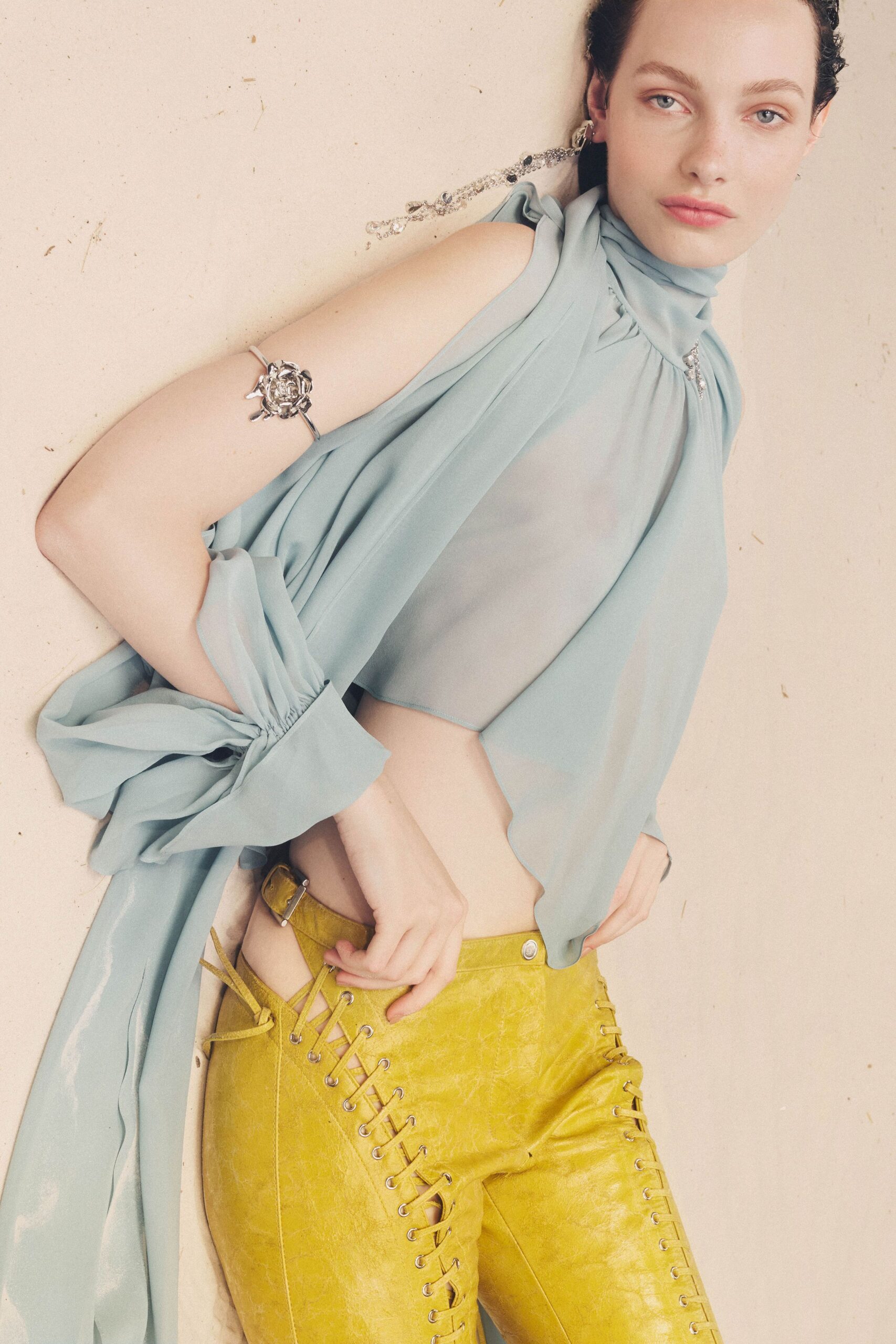 blue silk sleeveless top and yellow leather pants