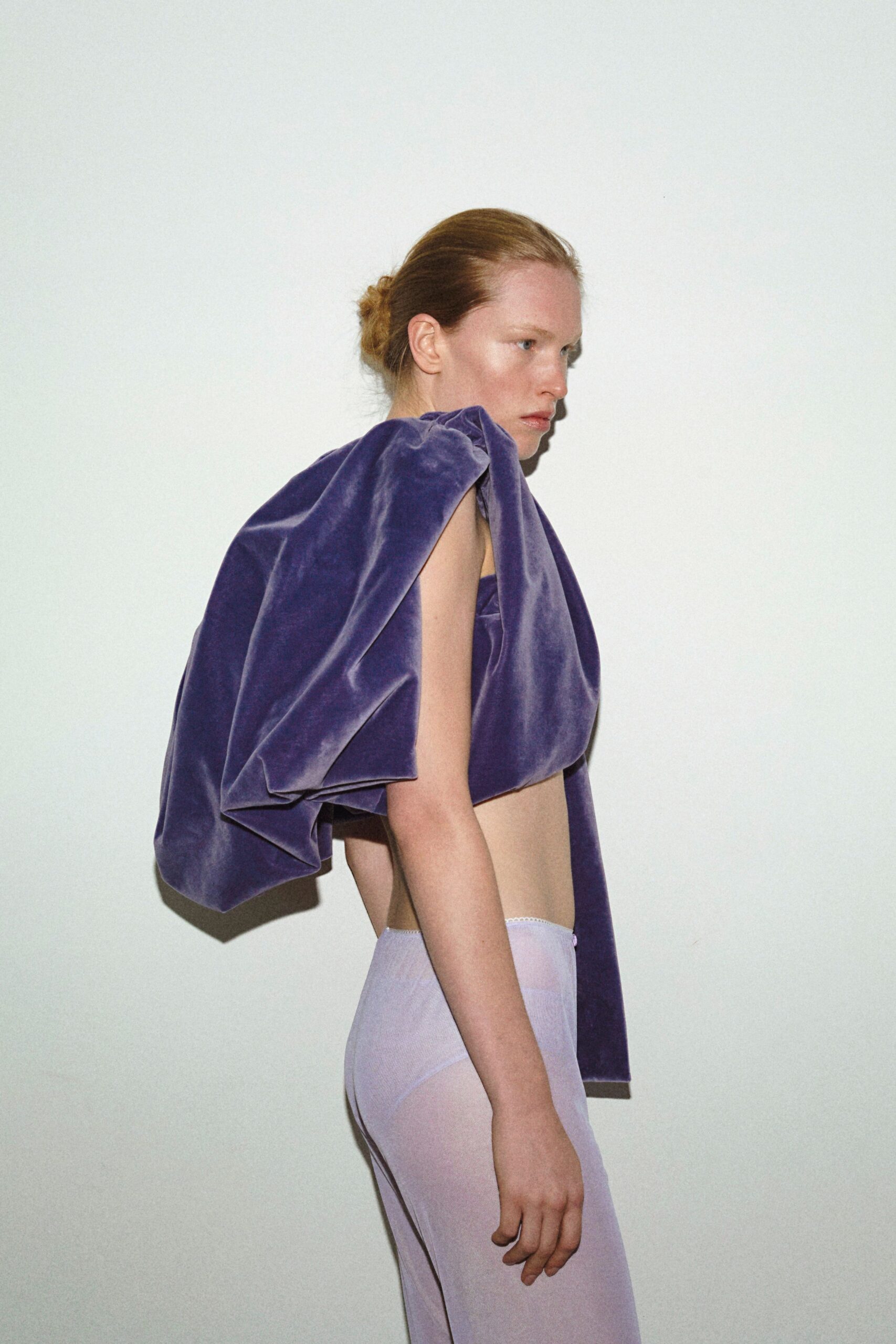 purple velvet top and white pants