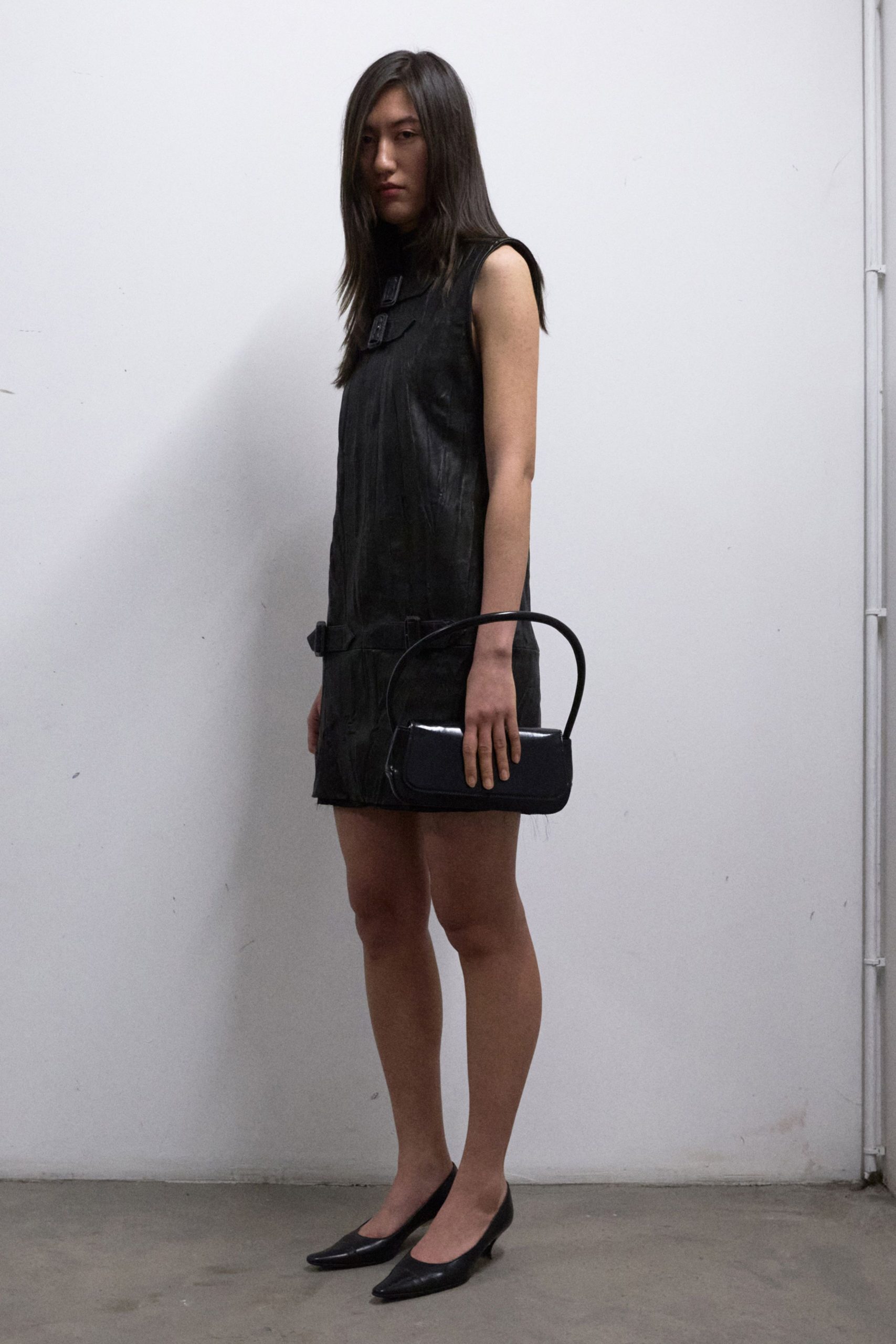 black leather sleeveless high-neck fitted pleated mini dress