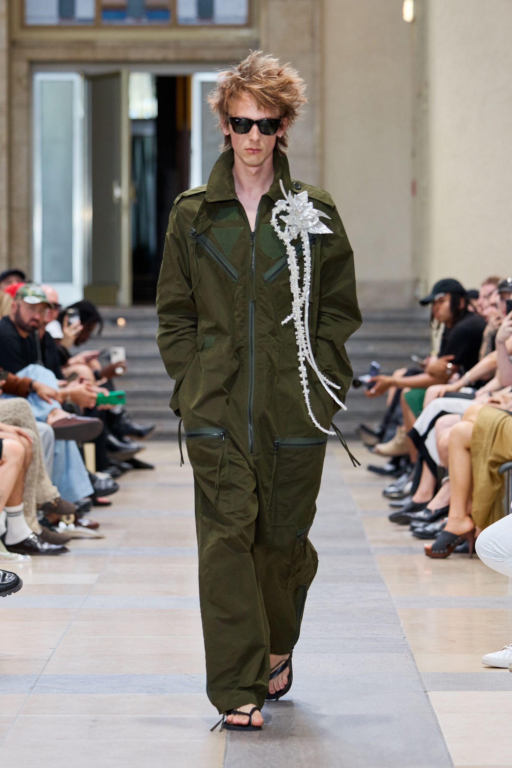 green fitted jumpsuit with sunglasses