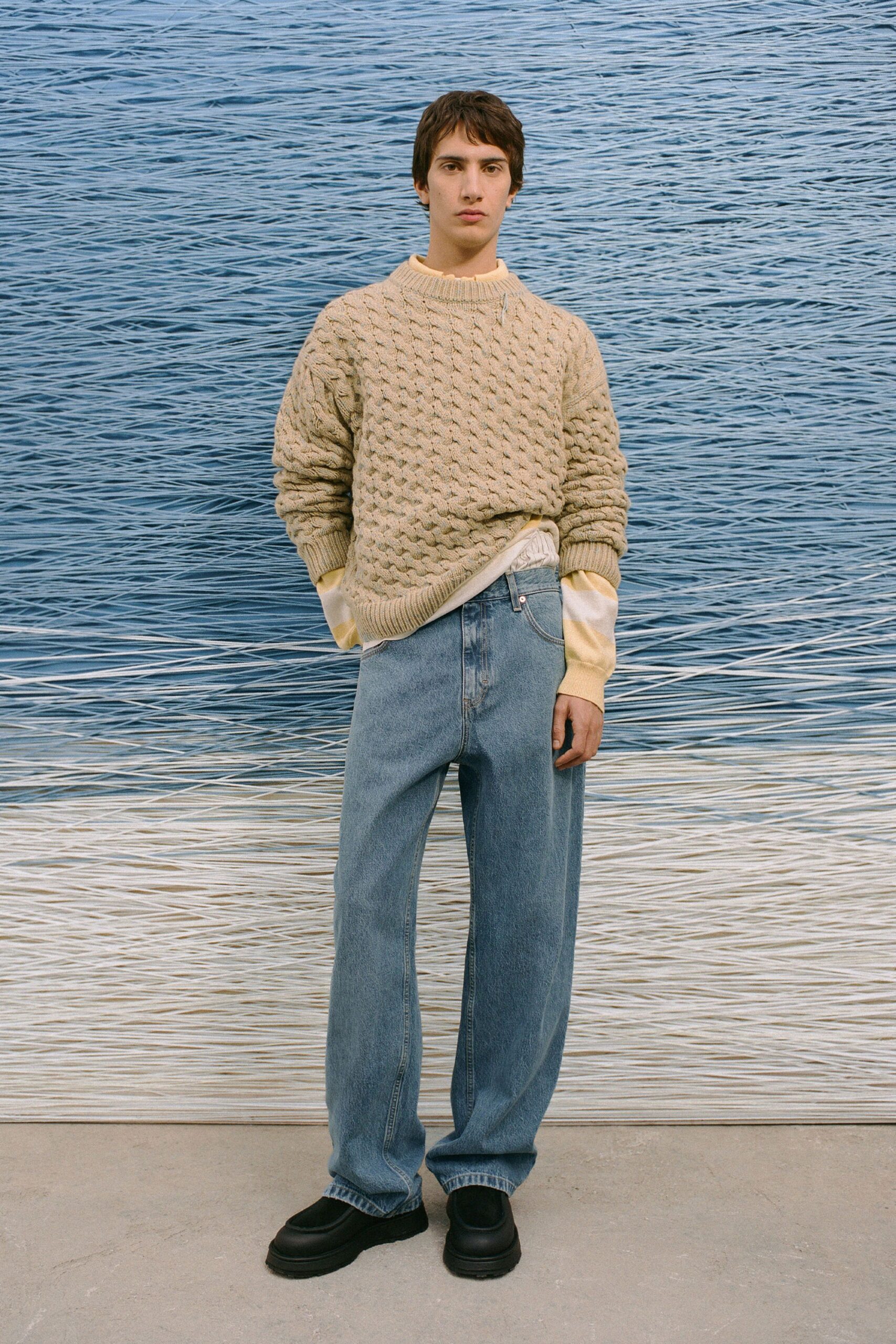 beige wool sweater with blue jeans