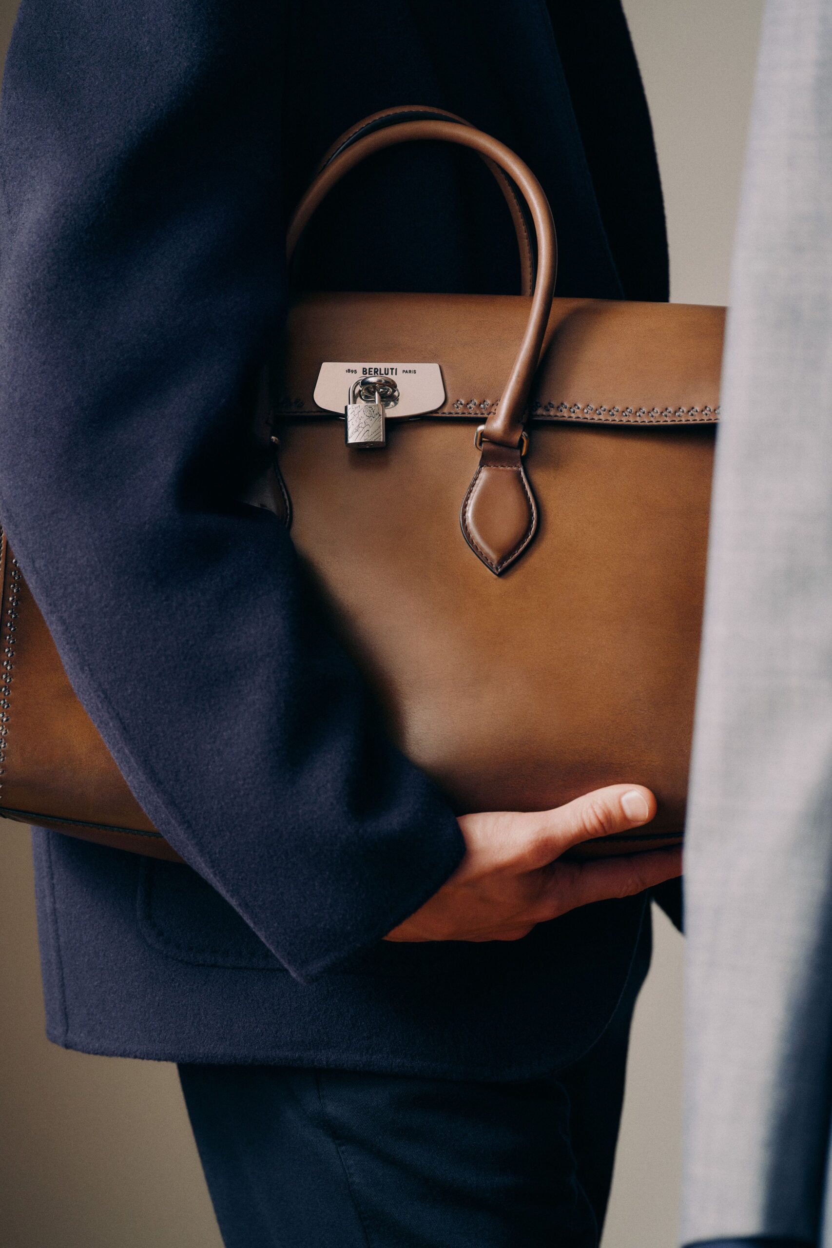 navy wool relaxed coat and brown leather bag