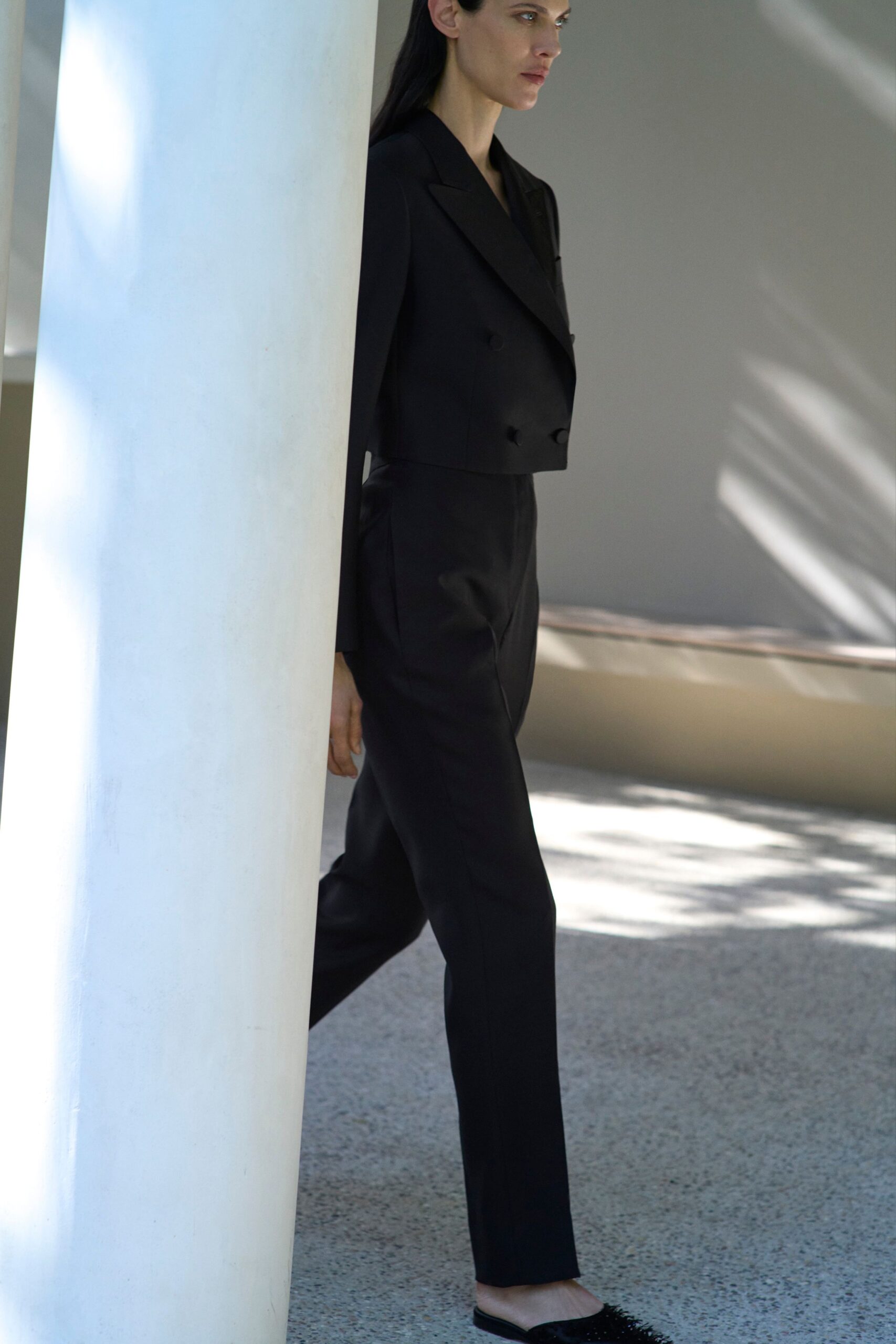 black fitted suit with flat shoes