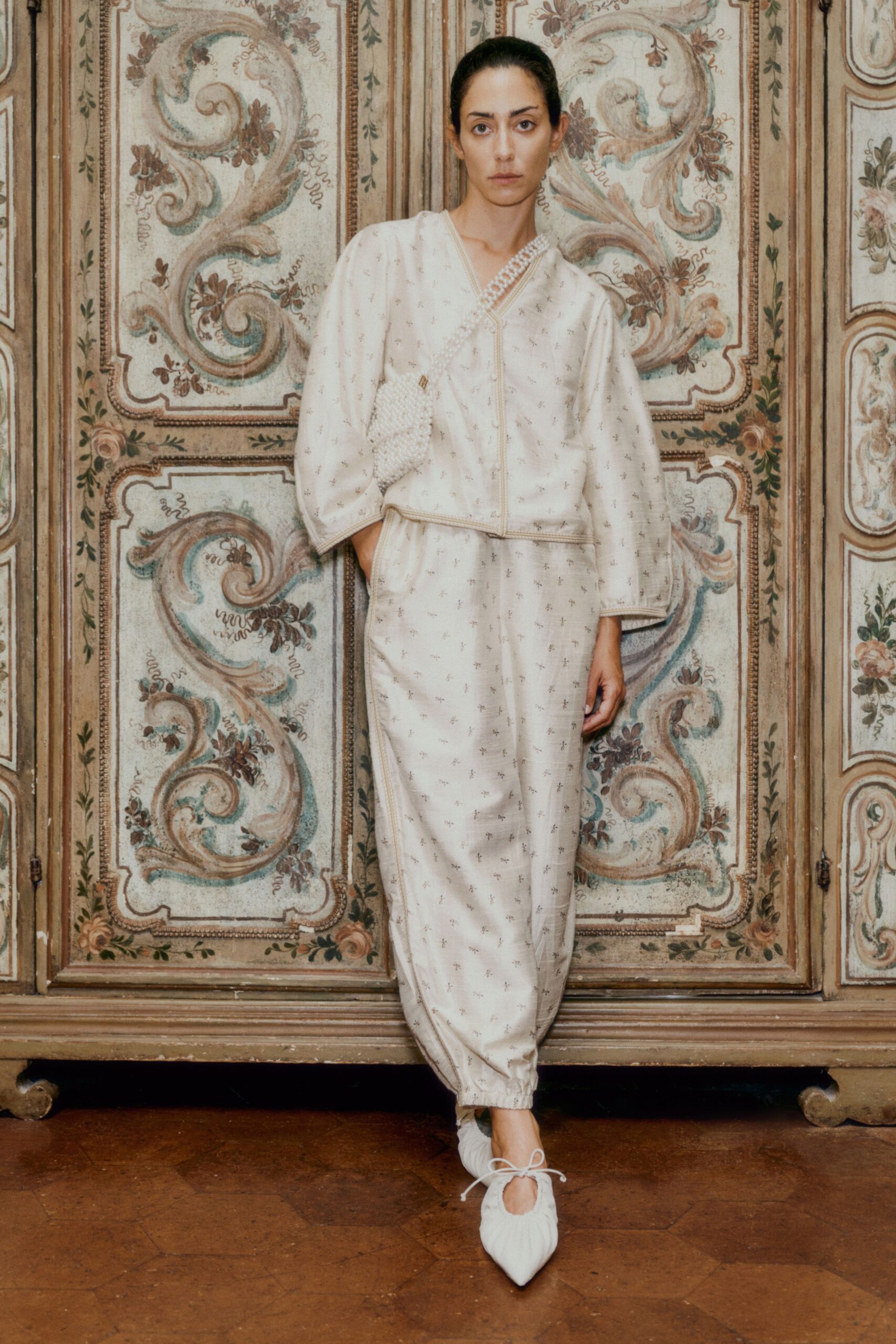 beige embroidered jumpsuit with white shoes