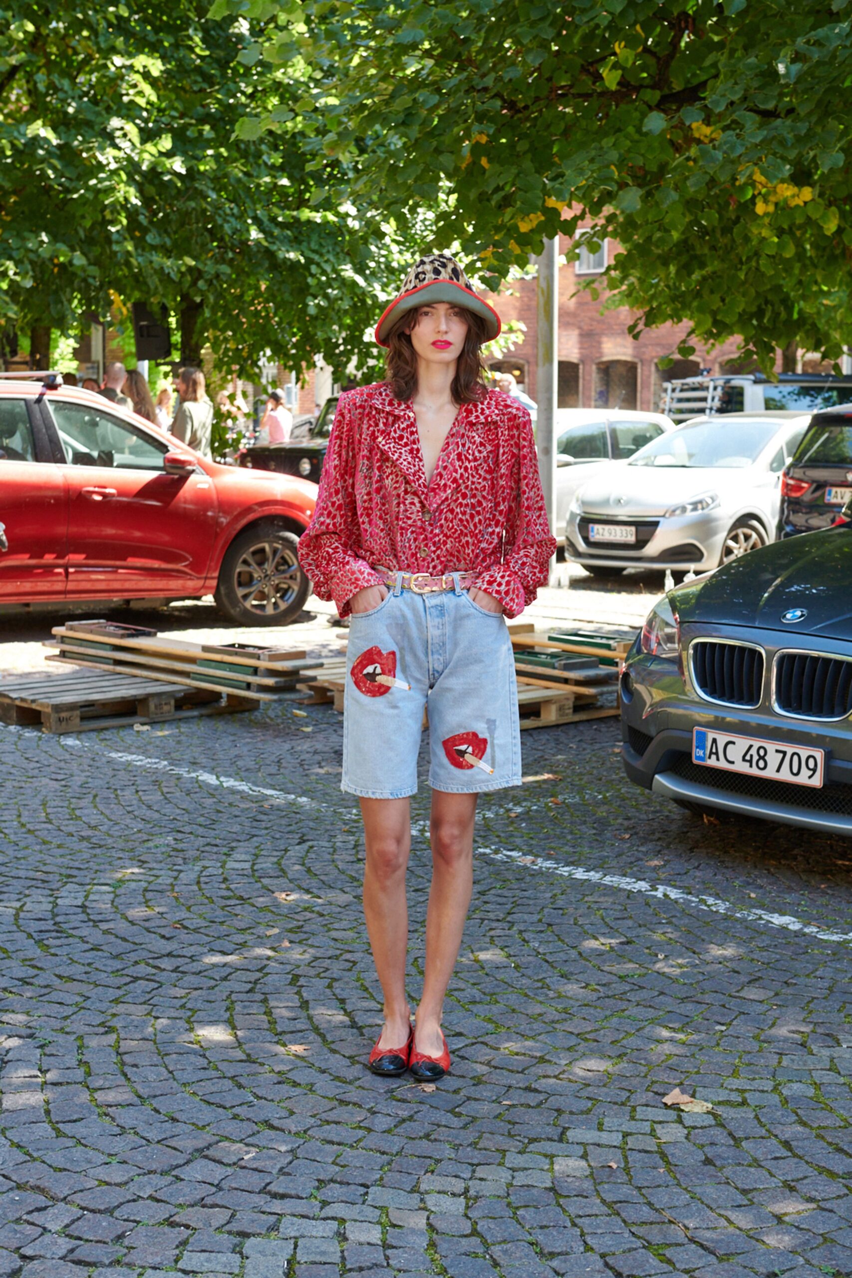 red printed shirt with denim shorts