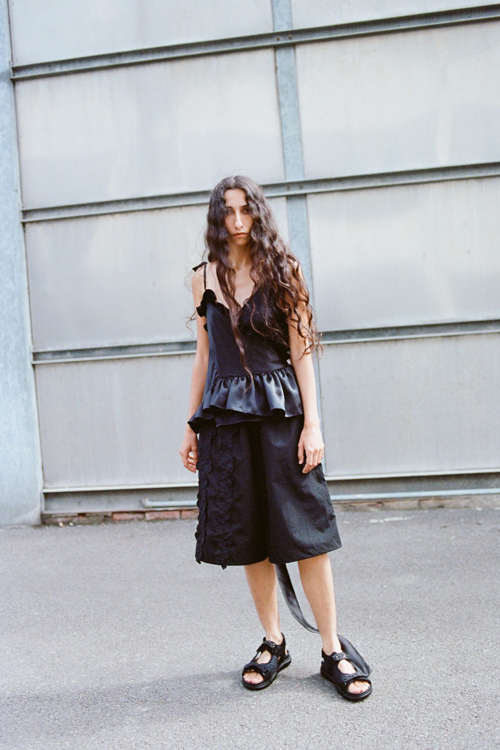 black fitted top and relaxed shorts