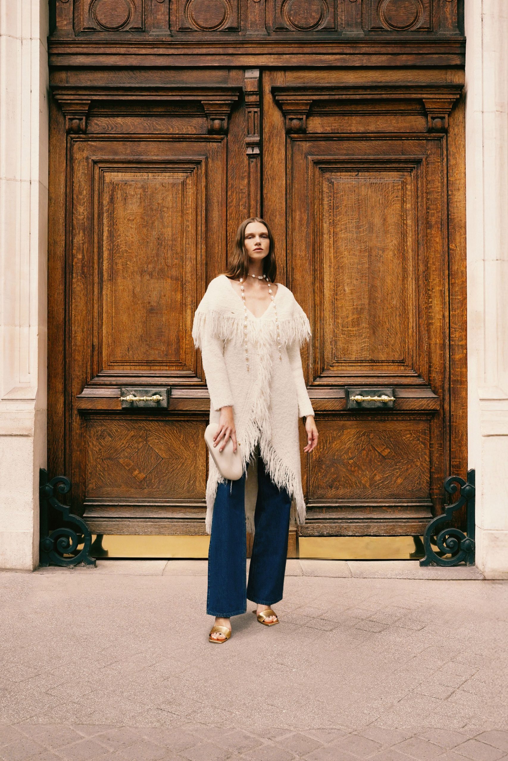 white fringed cardigan with denim pants