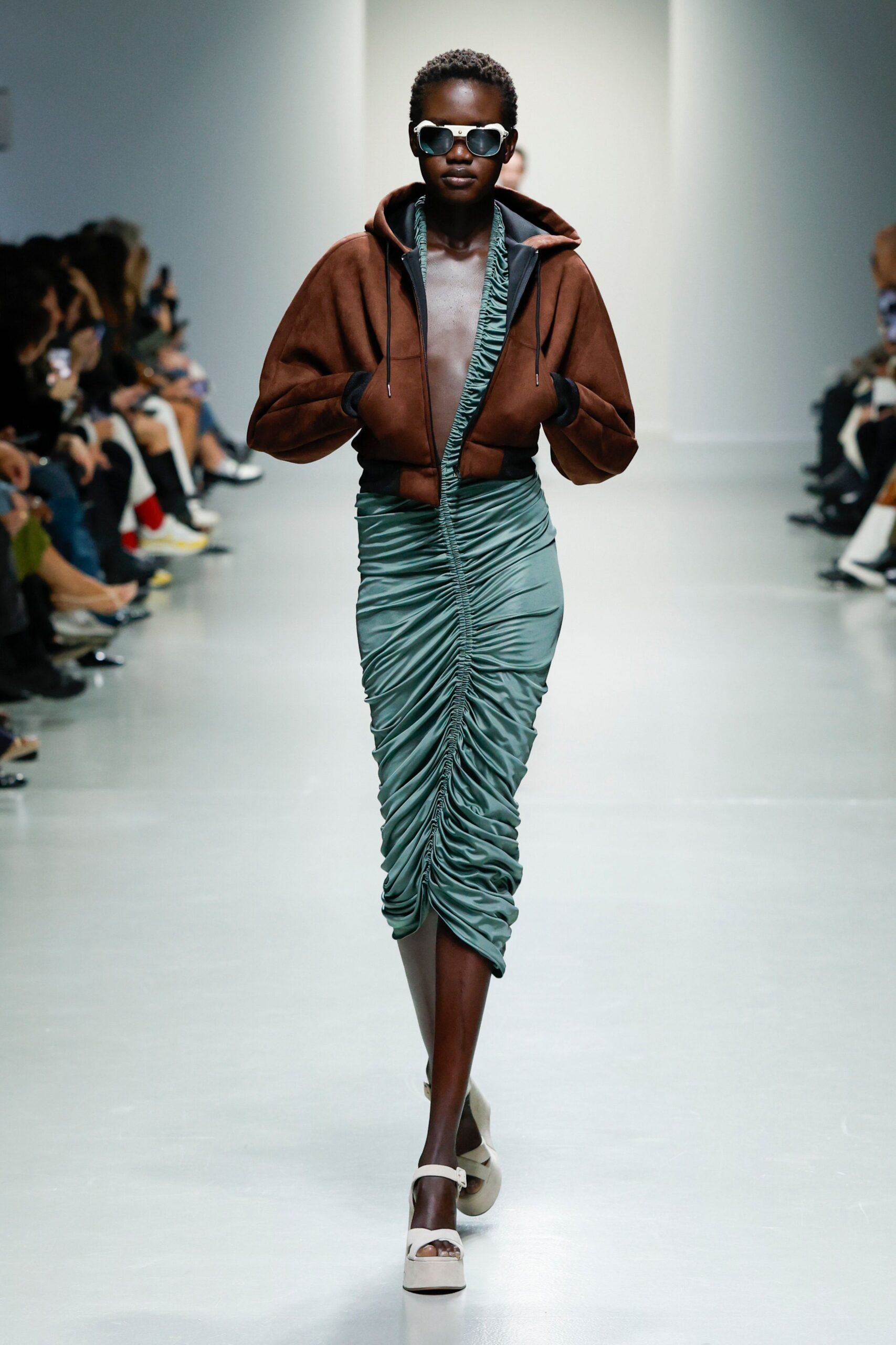 brown hooded jacket and green ruched dress