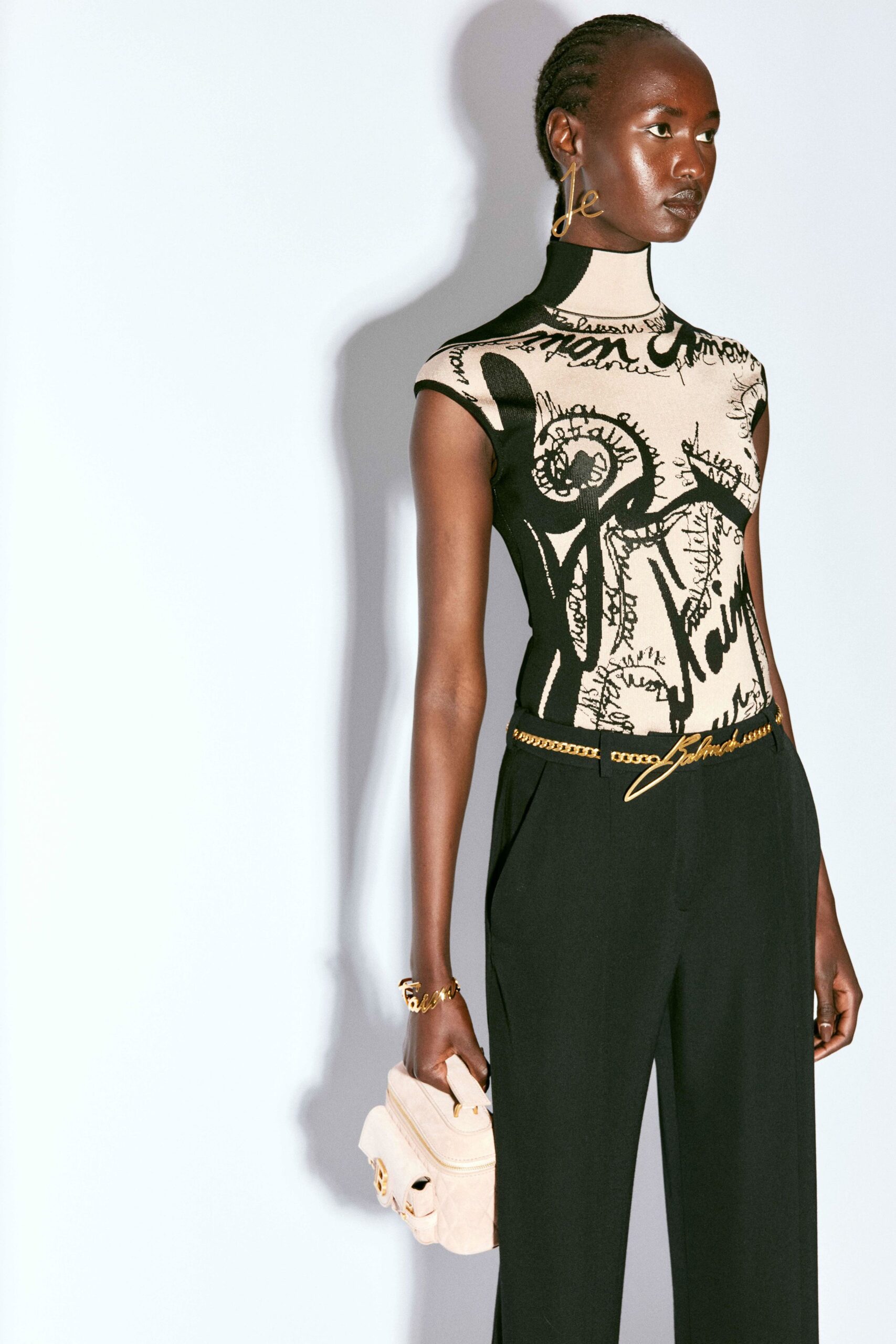beige printed top with black pants