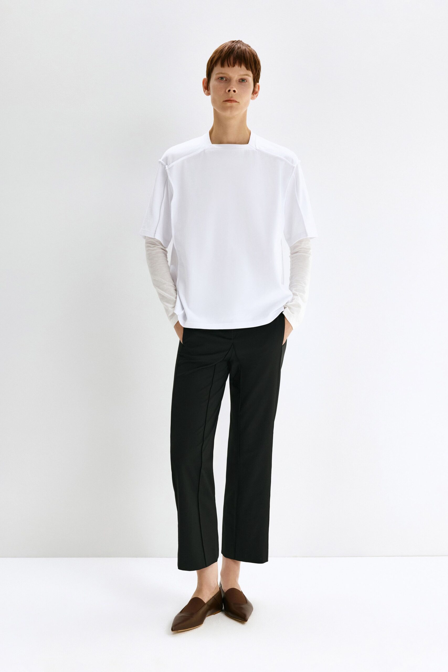 white relaxed top with black tailored pants