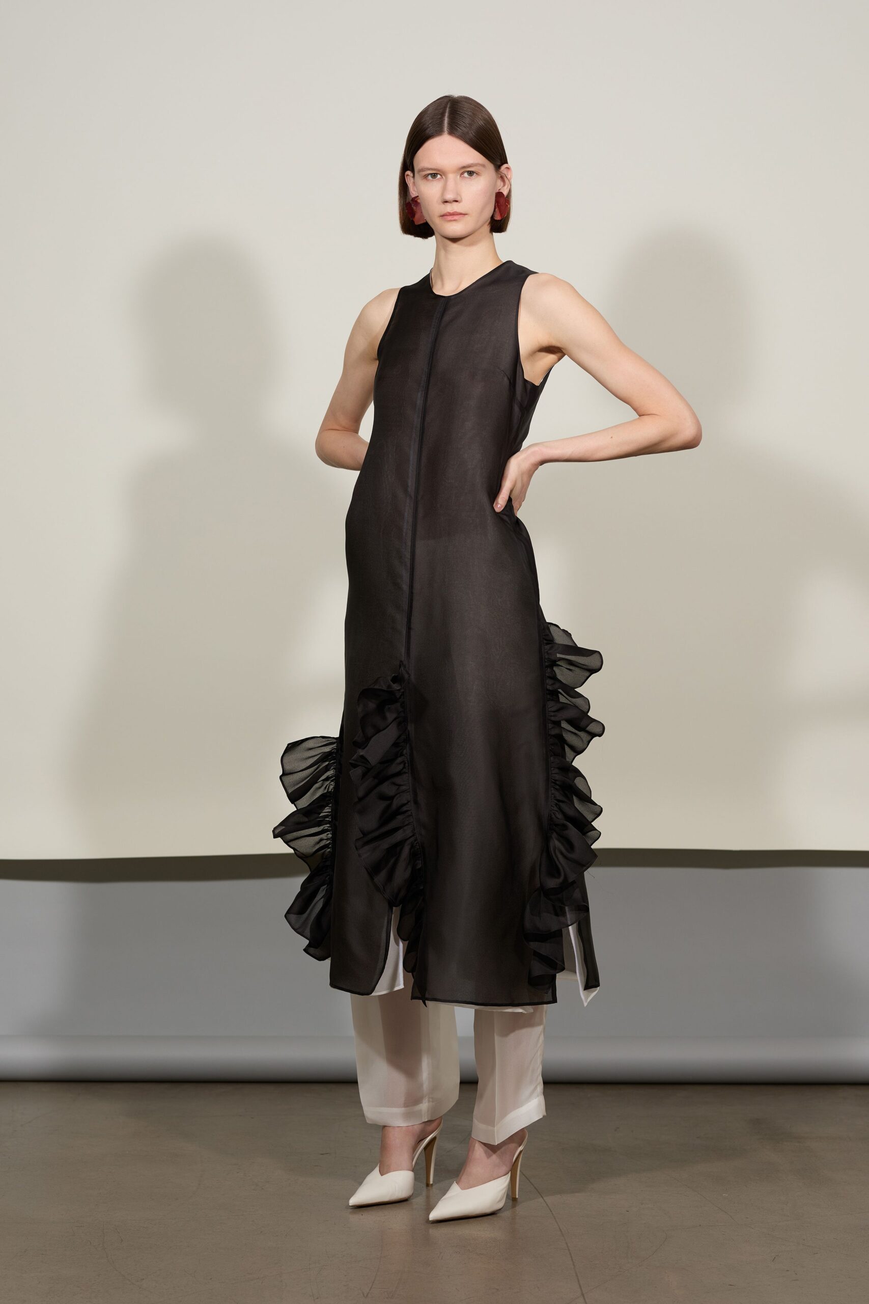 black ruffled midi dress with white pants