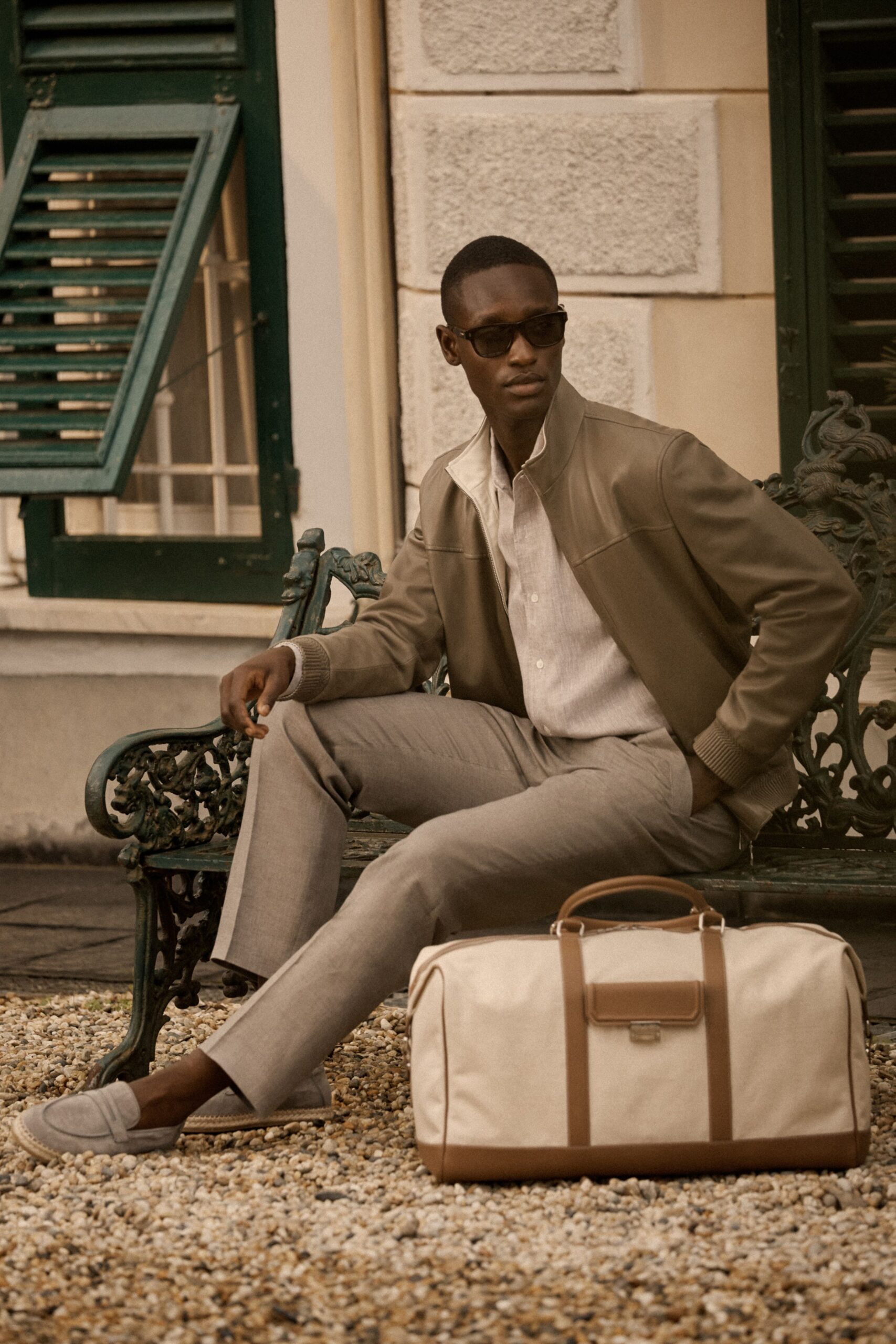 brown leather jacket with gray pants