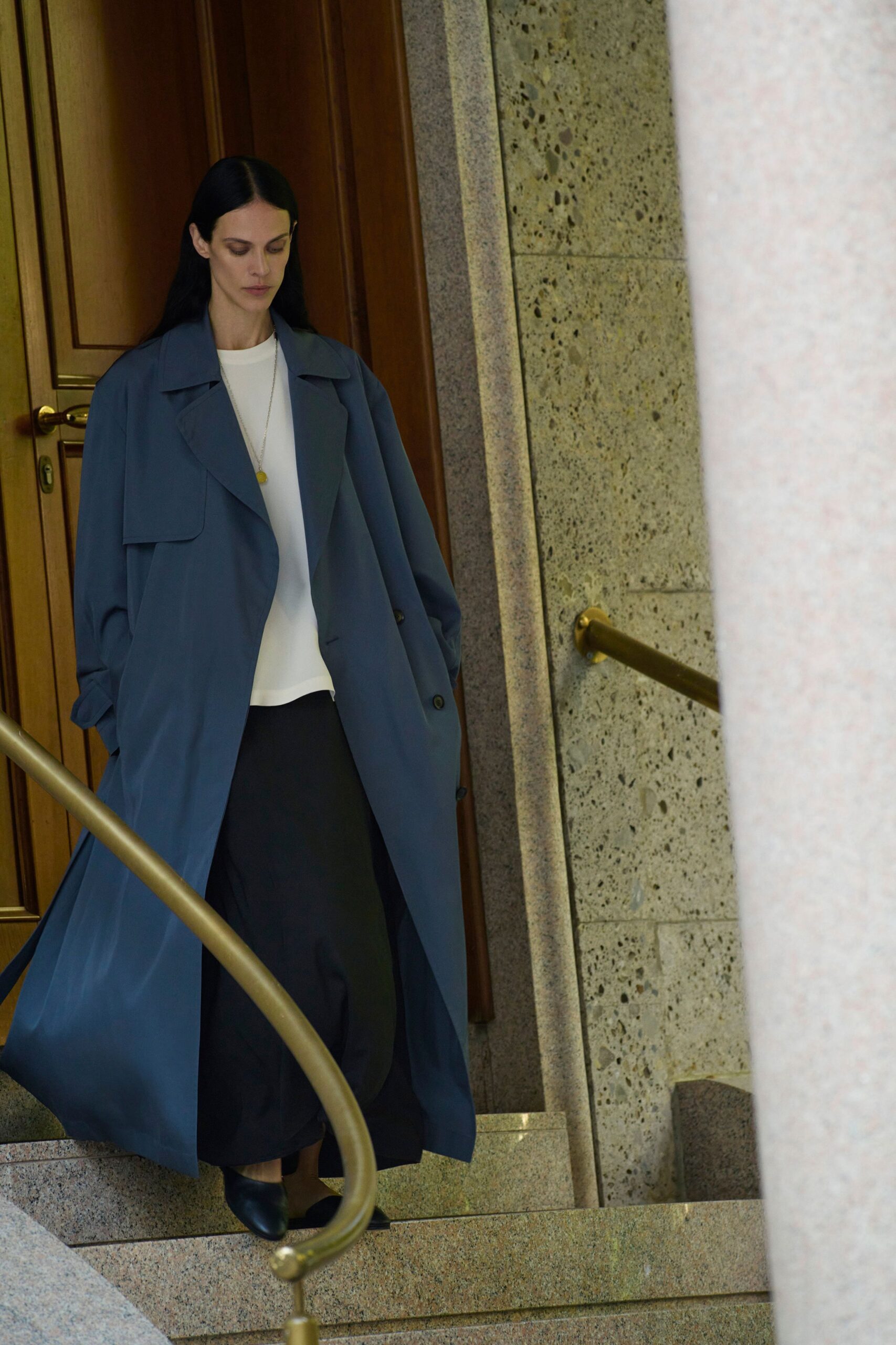blue coat white top black skirt