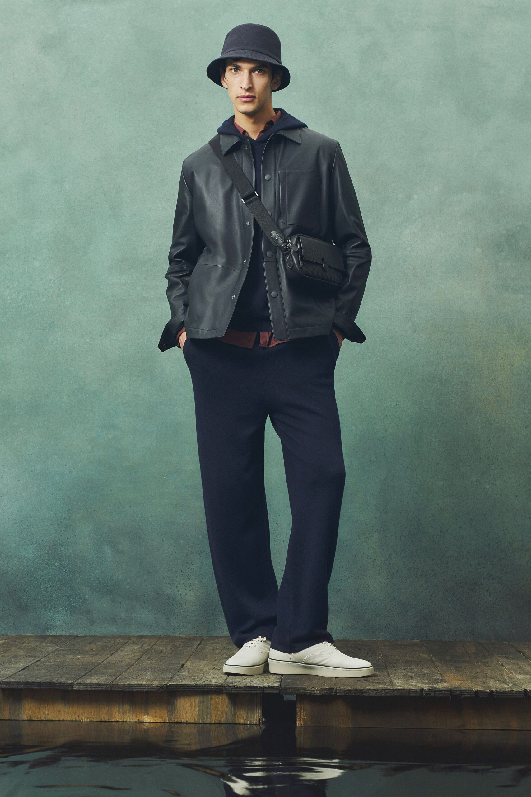black leather jacket with navy pants