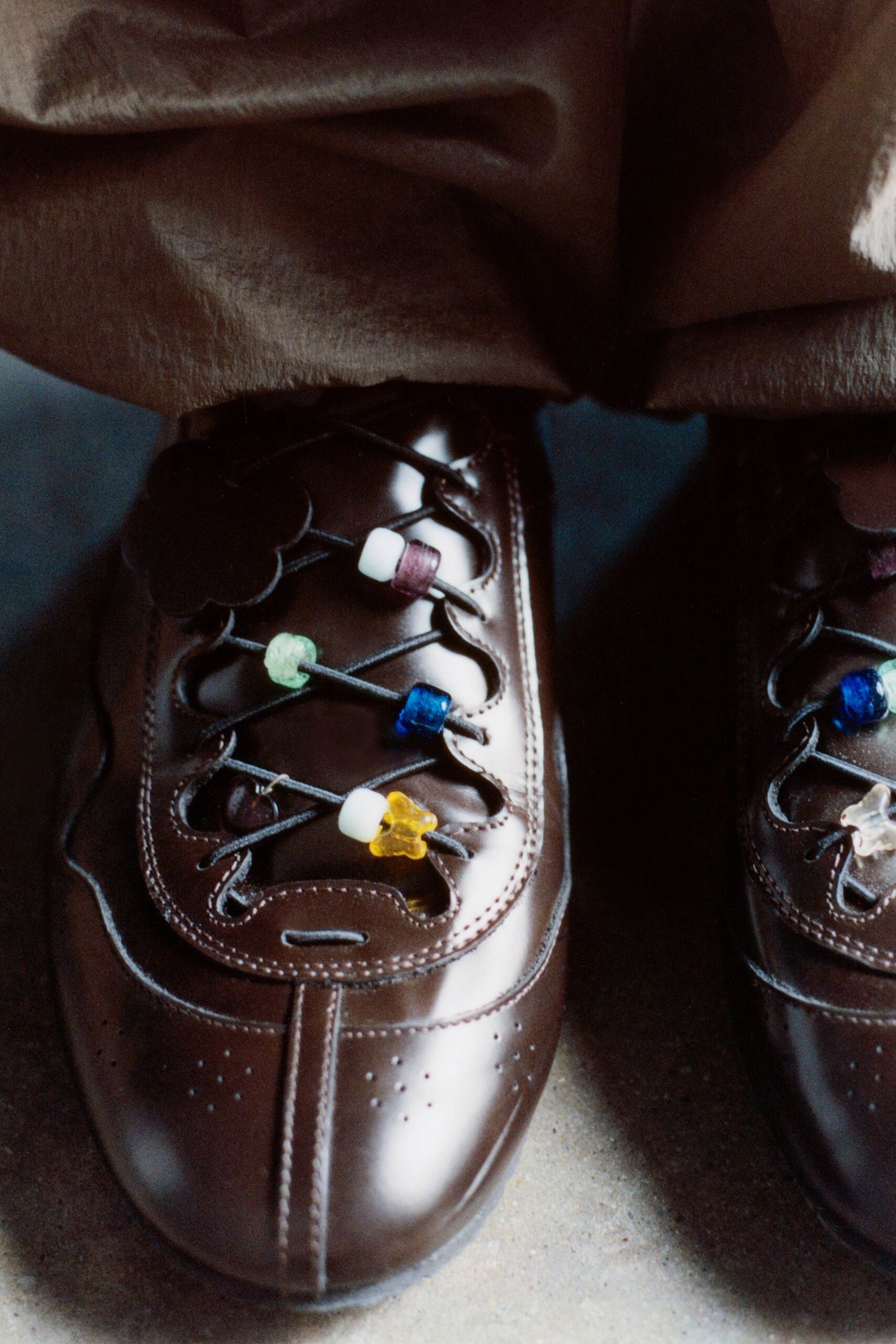 beige relaxed pants with brown shoes