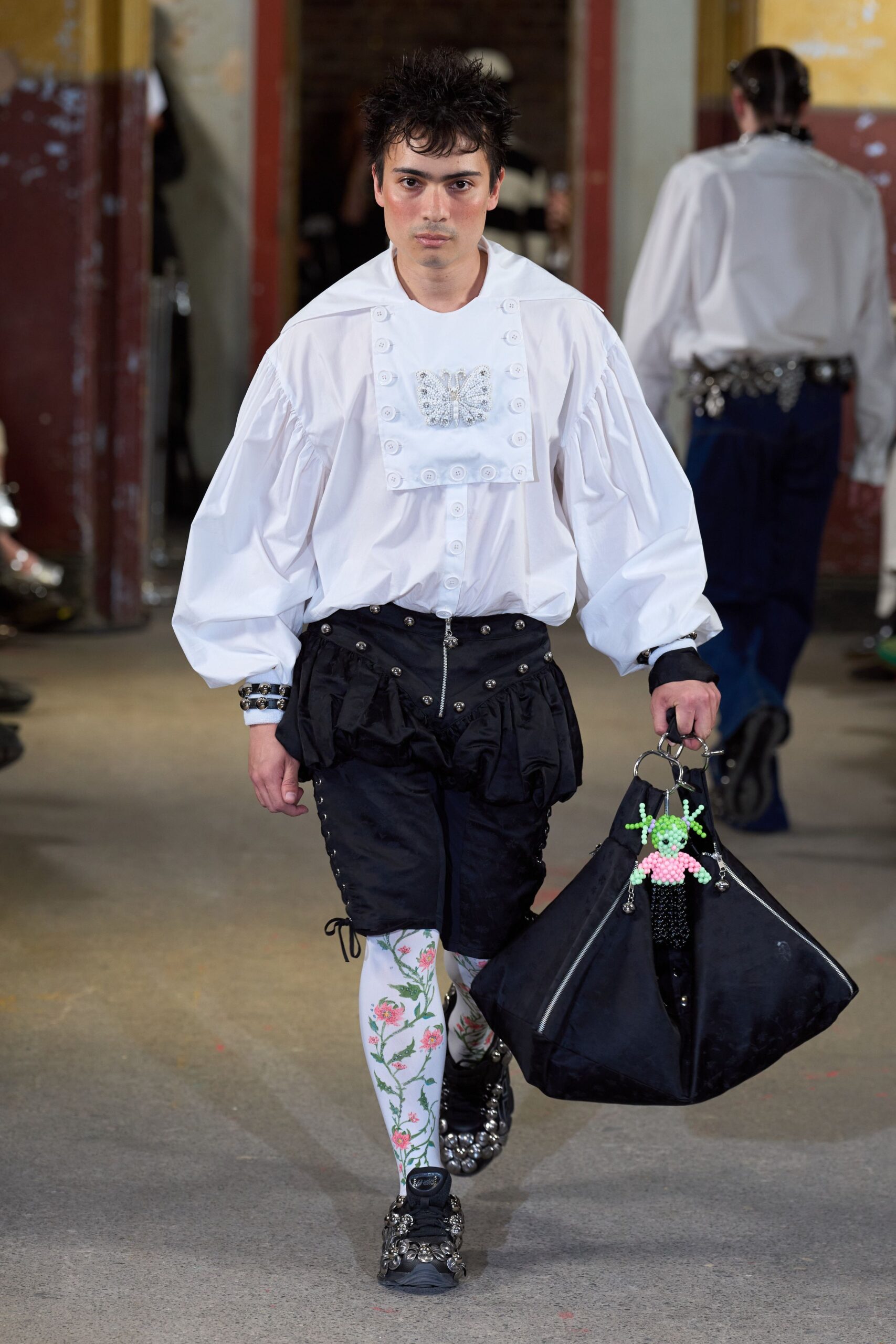 white relaxed shirt with black shorts