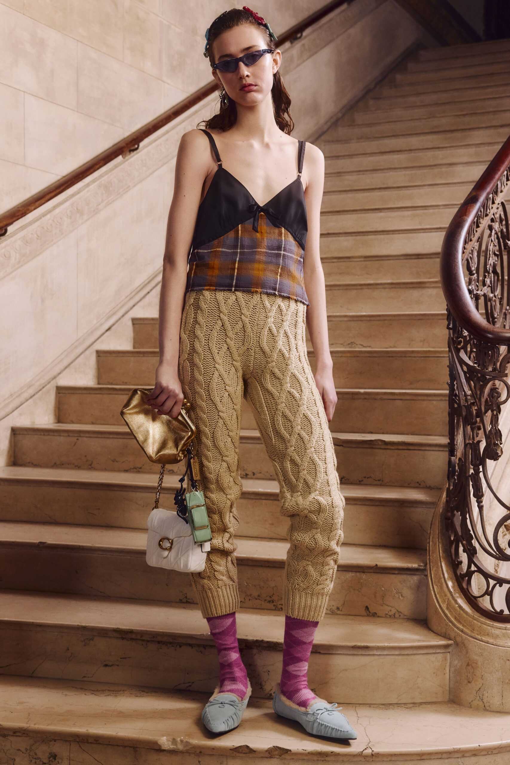 layered black silk top with beige pants