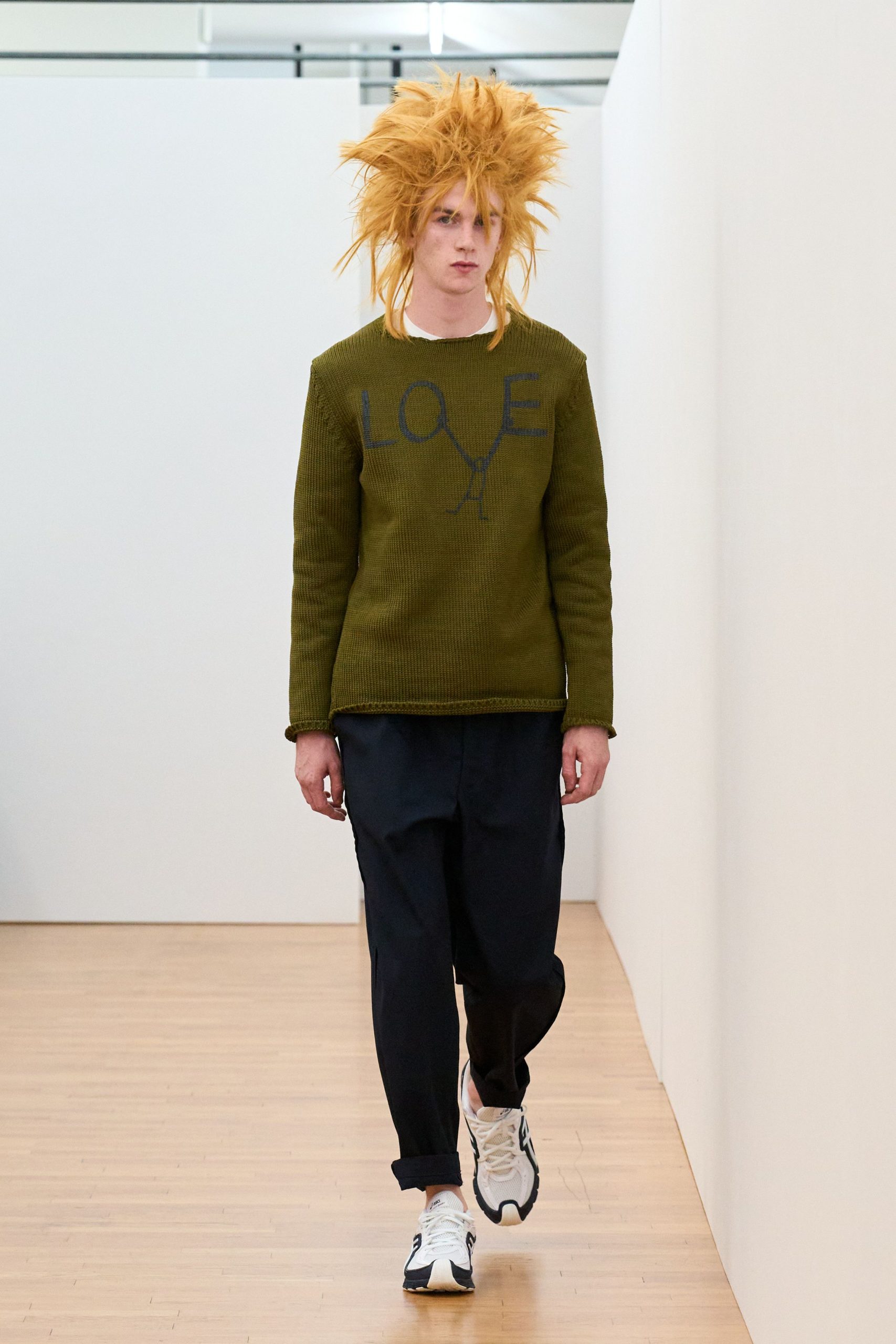green printed sweater with black pants