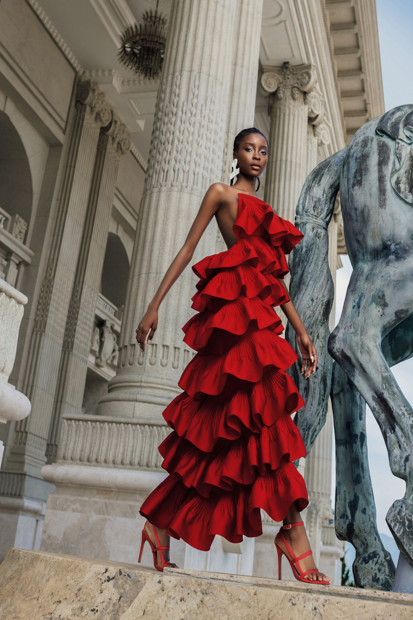 red silk sleeveless off-shoulder fitted ruffled tiered gown