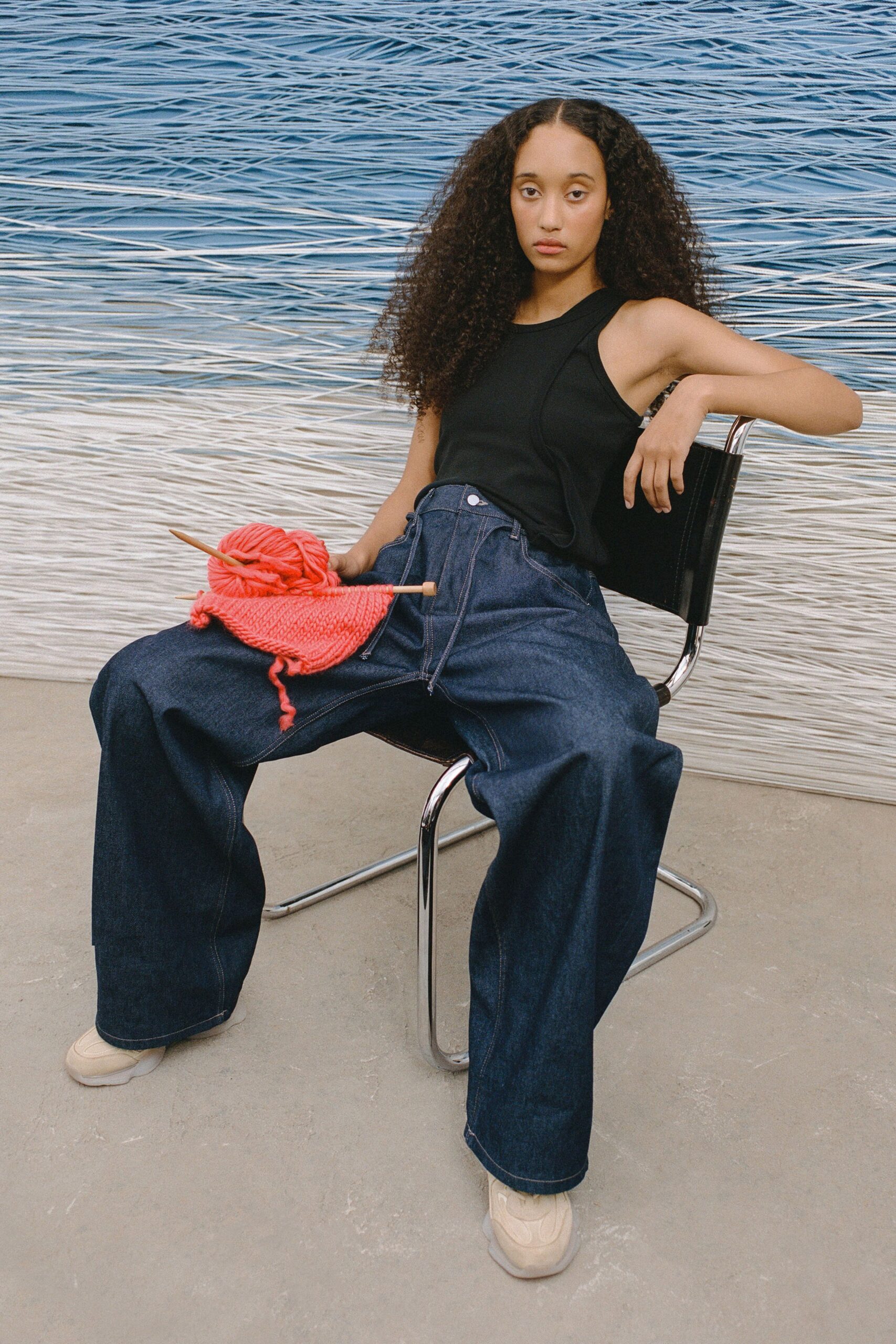 black tank-top and blue wide-leg pants
