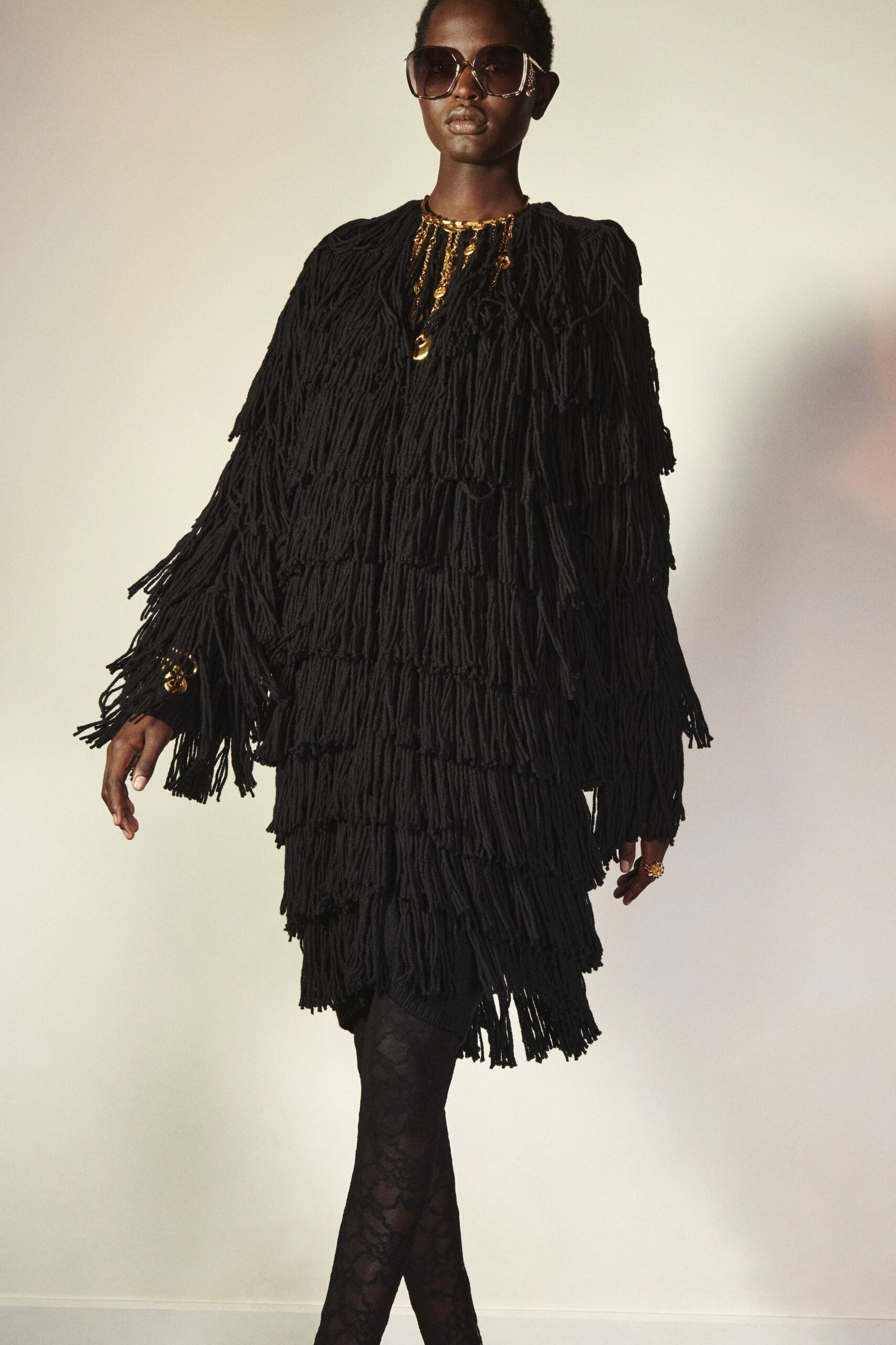 black fringed mini dress with sunglasses