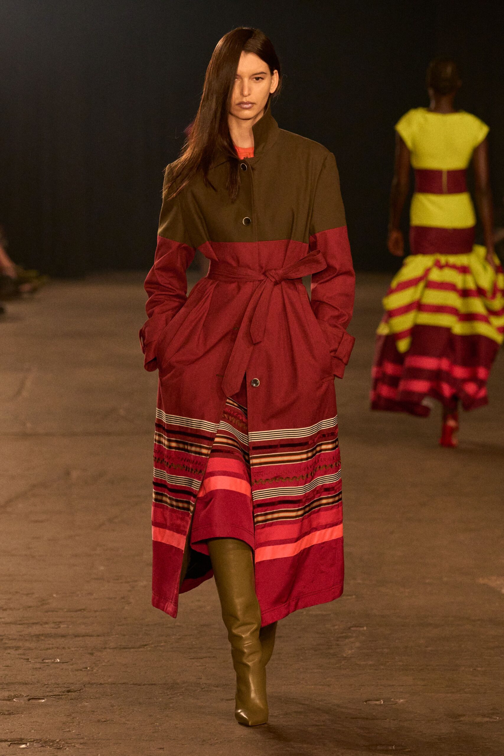 brown and red belted coat with green boots