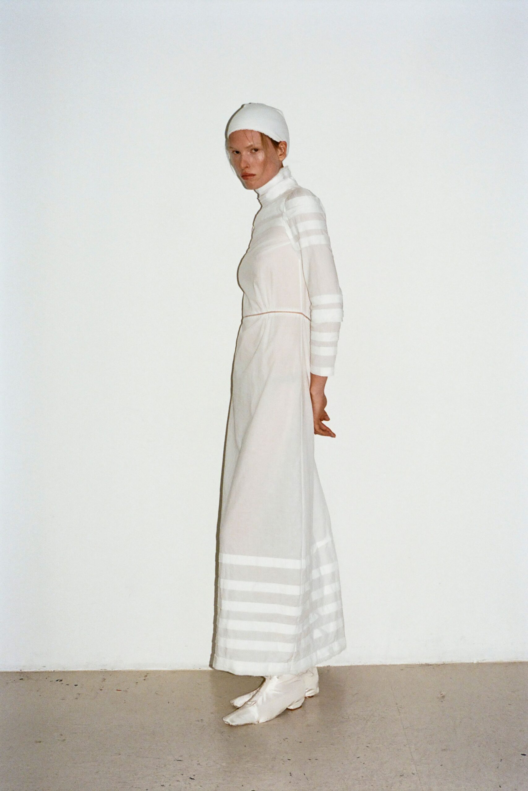 white cotton long-sleeve high-neck fitted striped belted gown