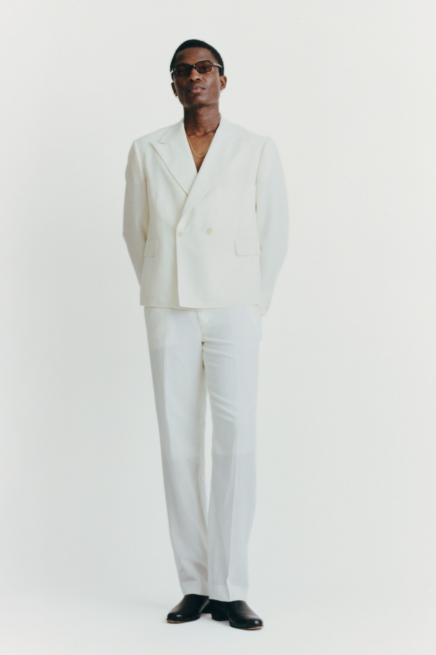 white tailored suit with black shoes