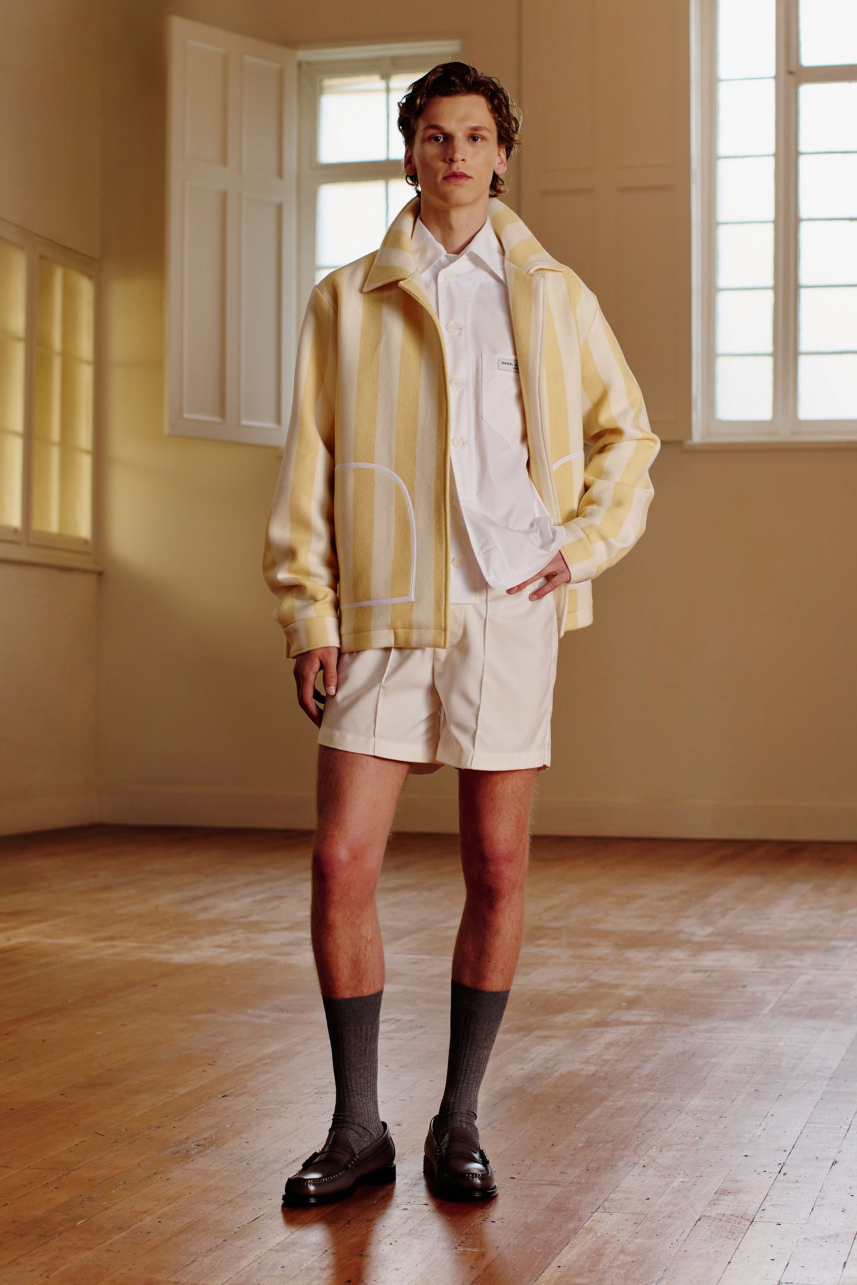 yellow striped jacket with beige shorts