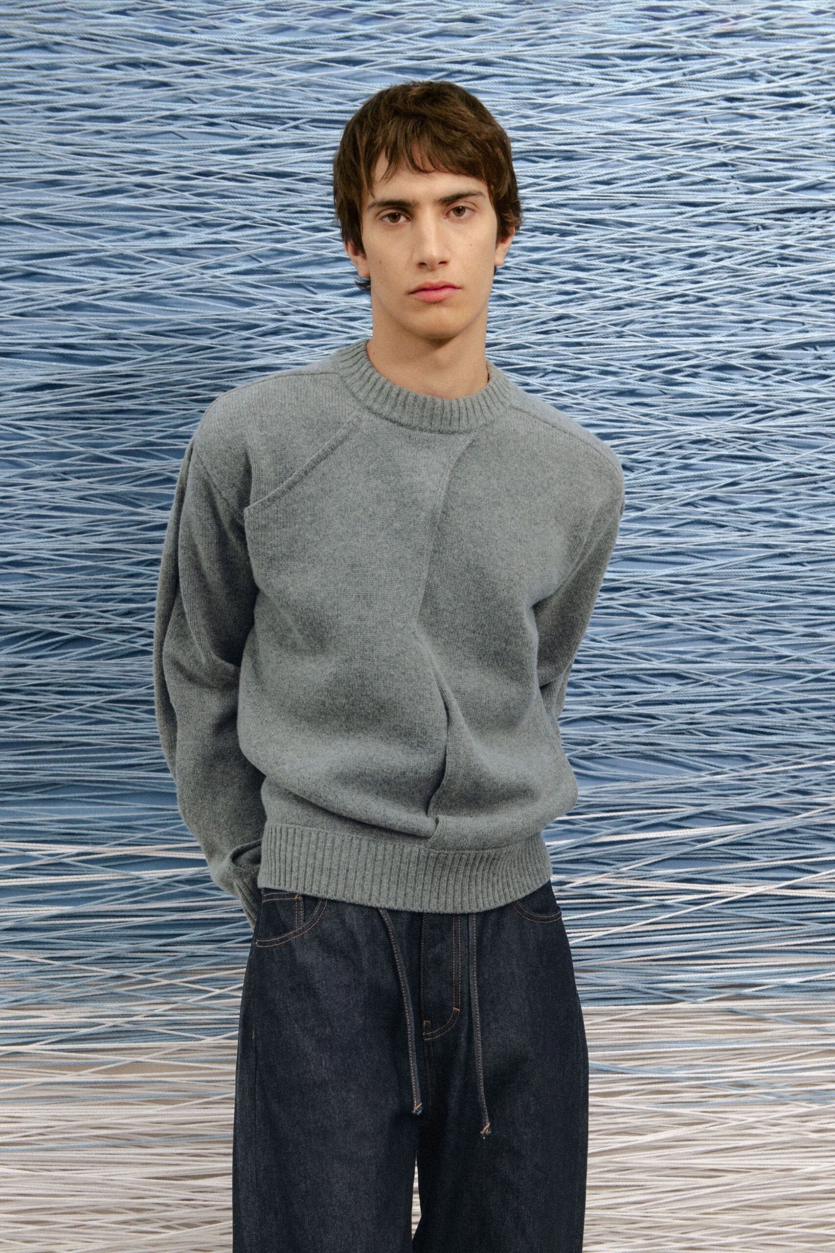 gray wool sweater and blue denim pants