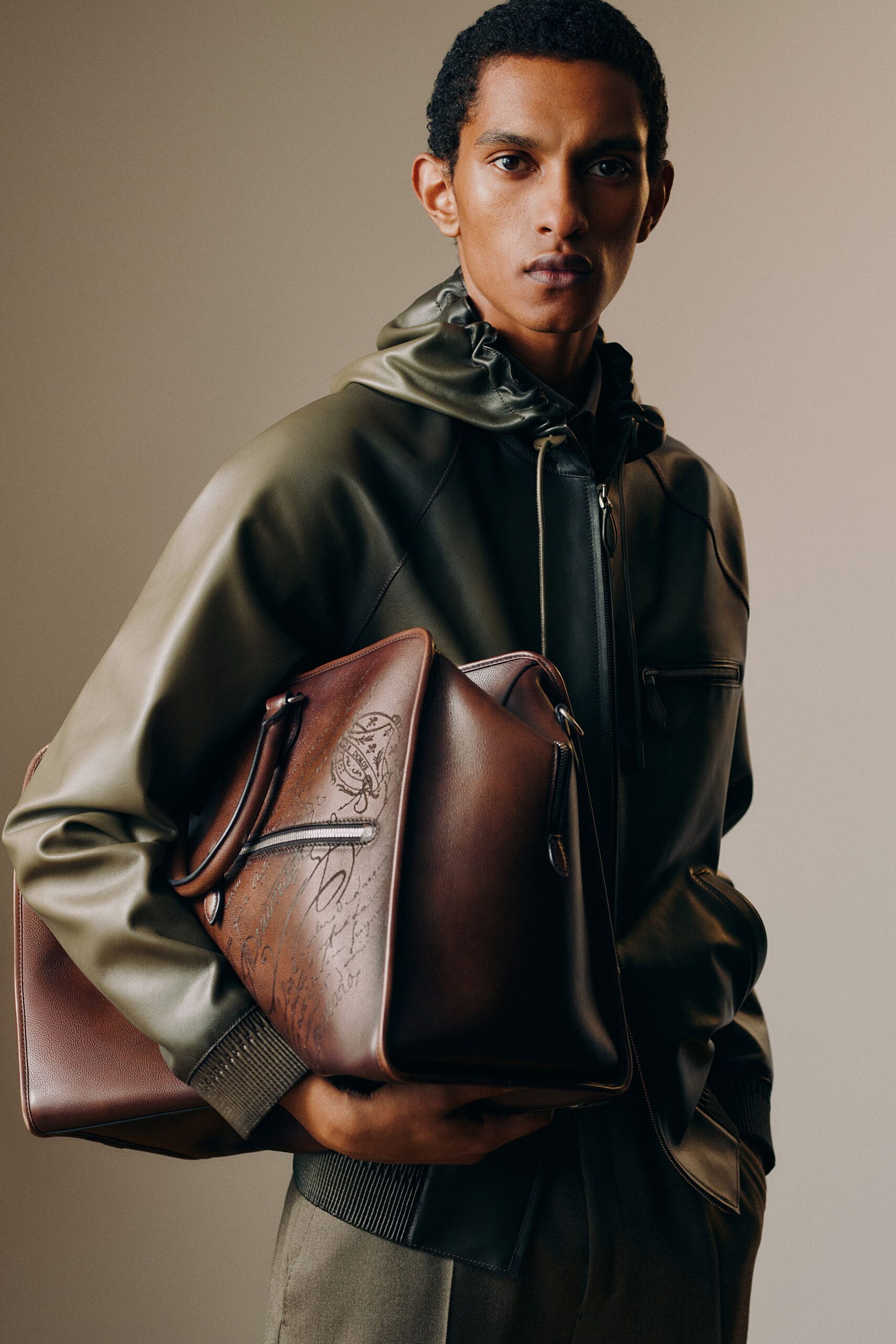 green leather hoodie with gray pants