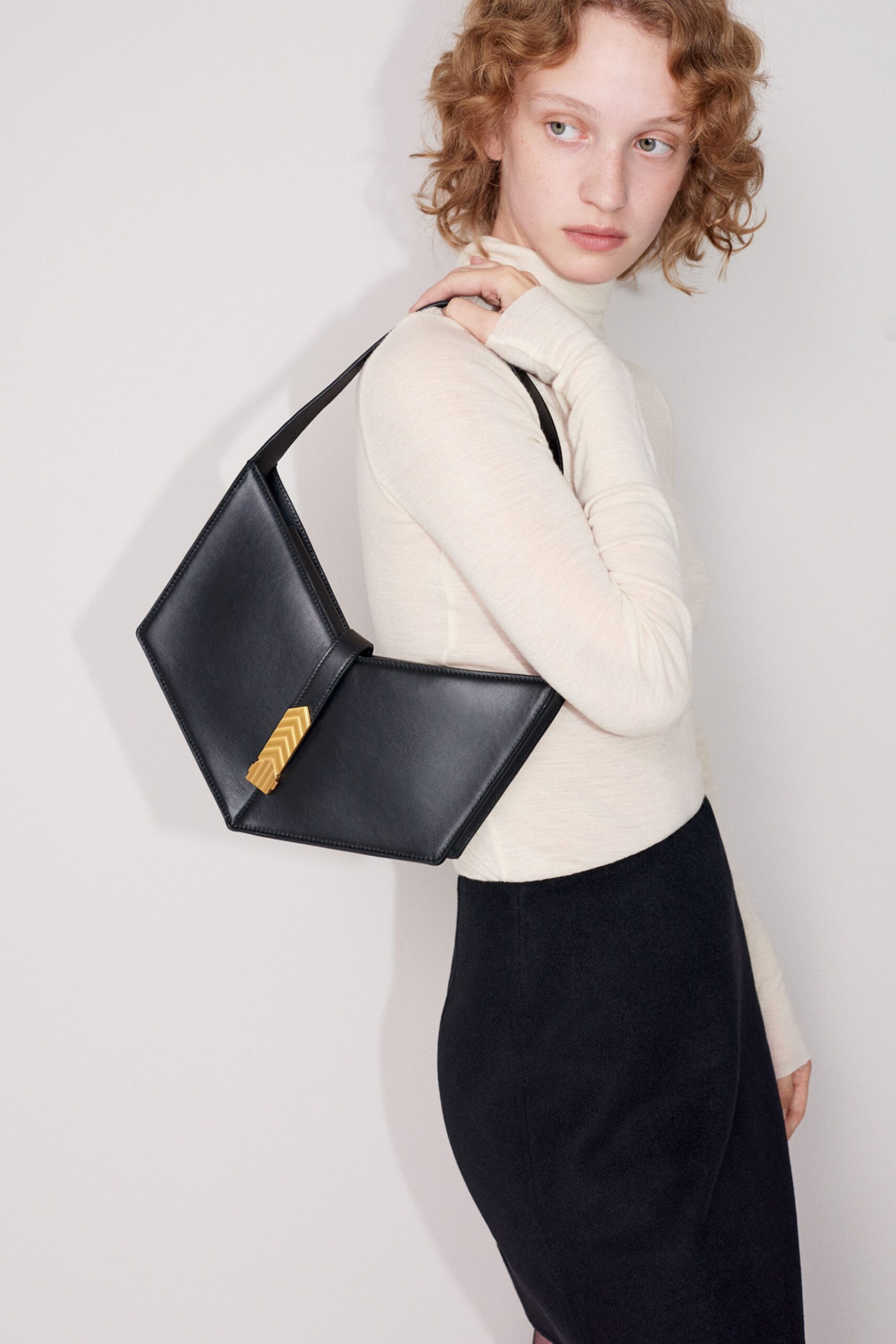 beige fitted turtleneck top with black pencil skirt