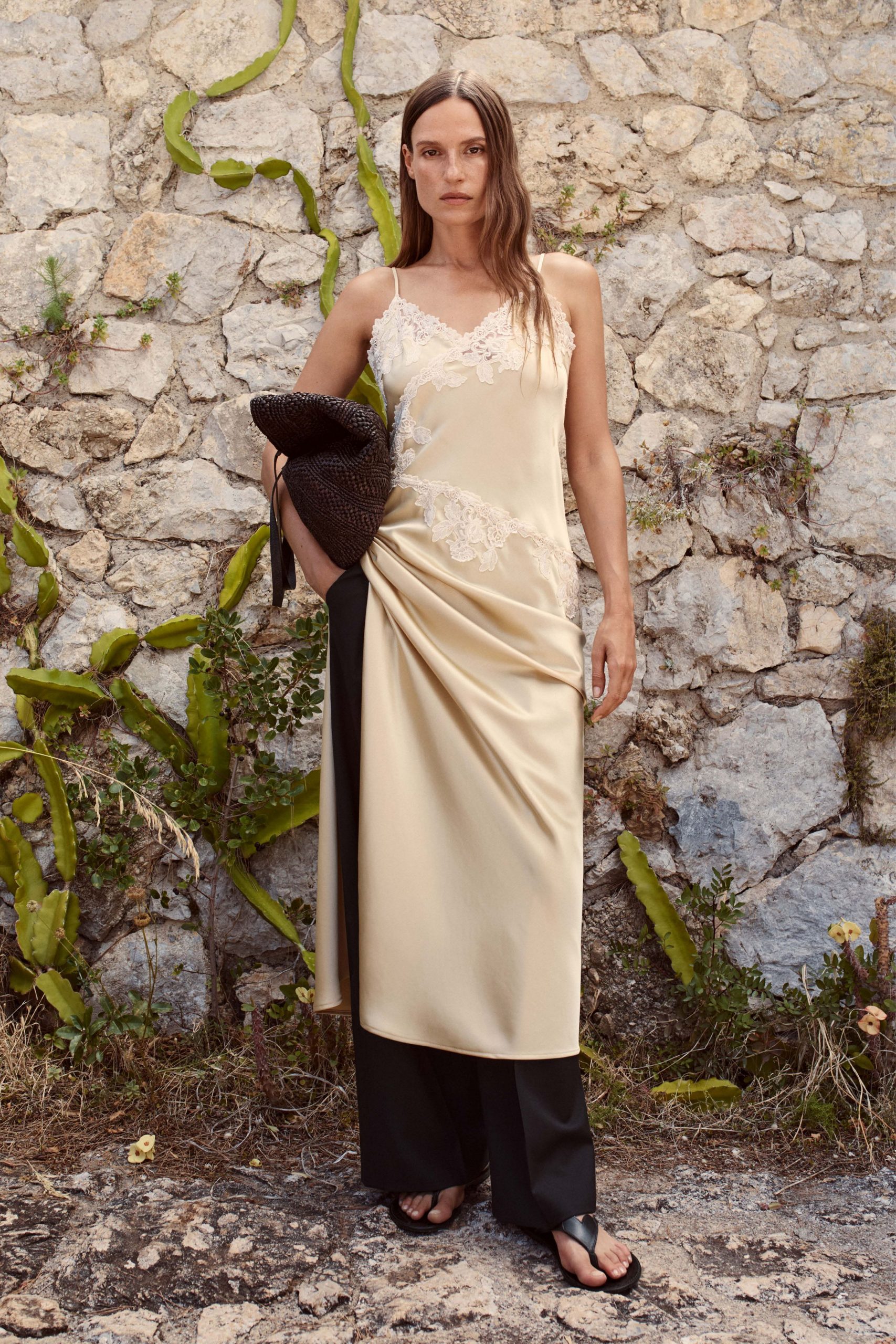 beige silk sleeveless dress with black pants