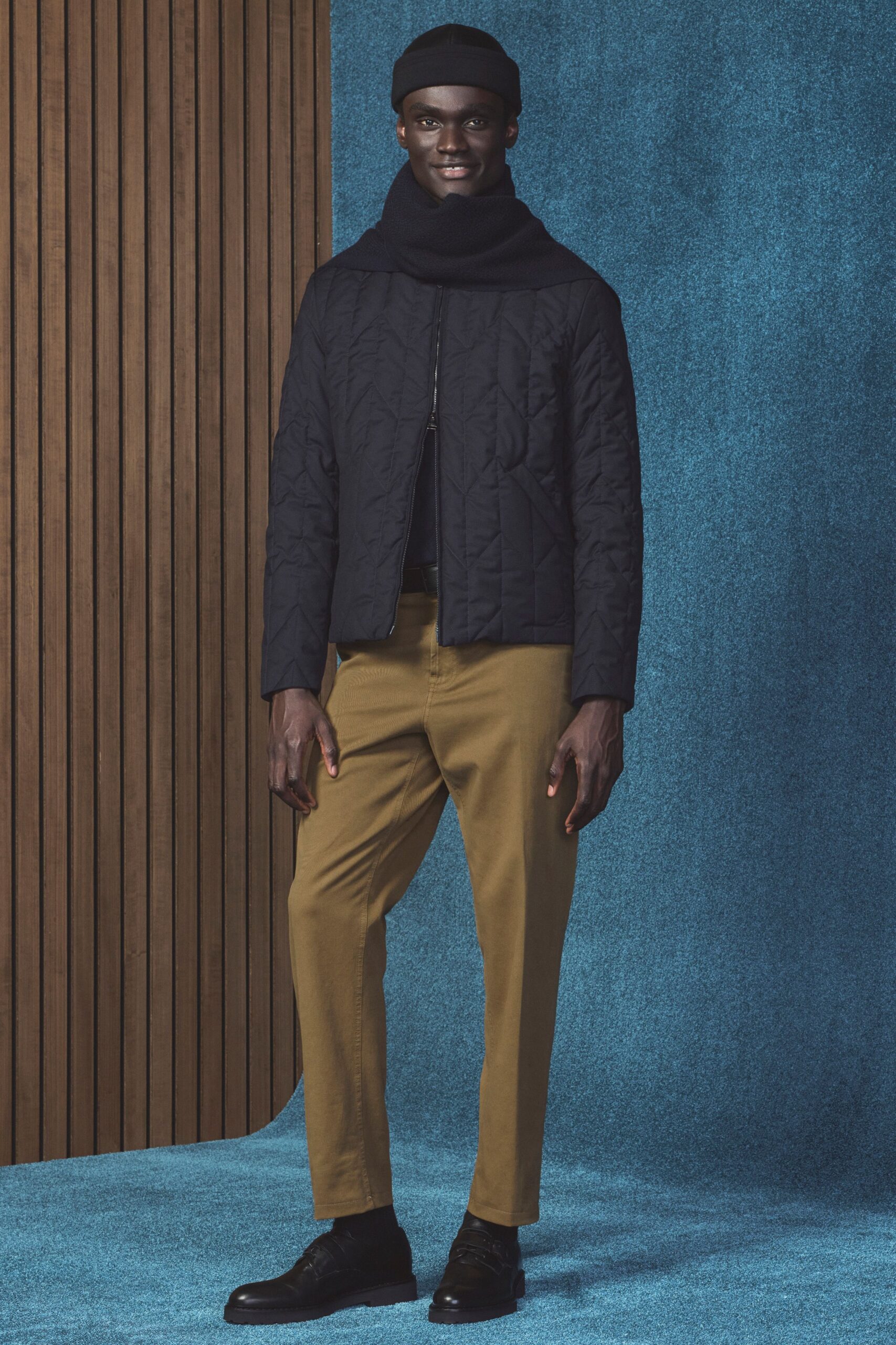 black quilted jacket with brown pants
