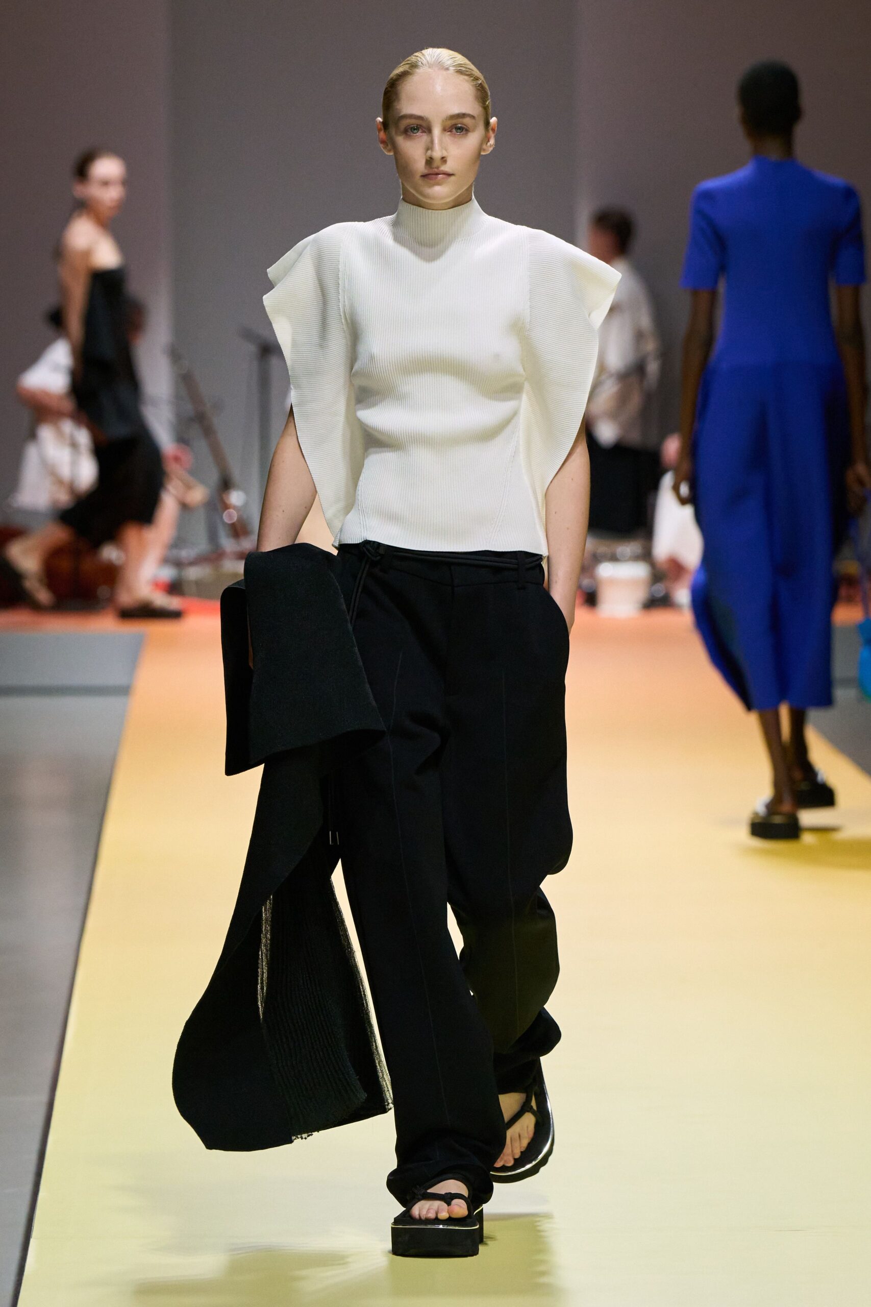 white pleated top with black pants