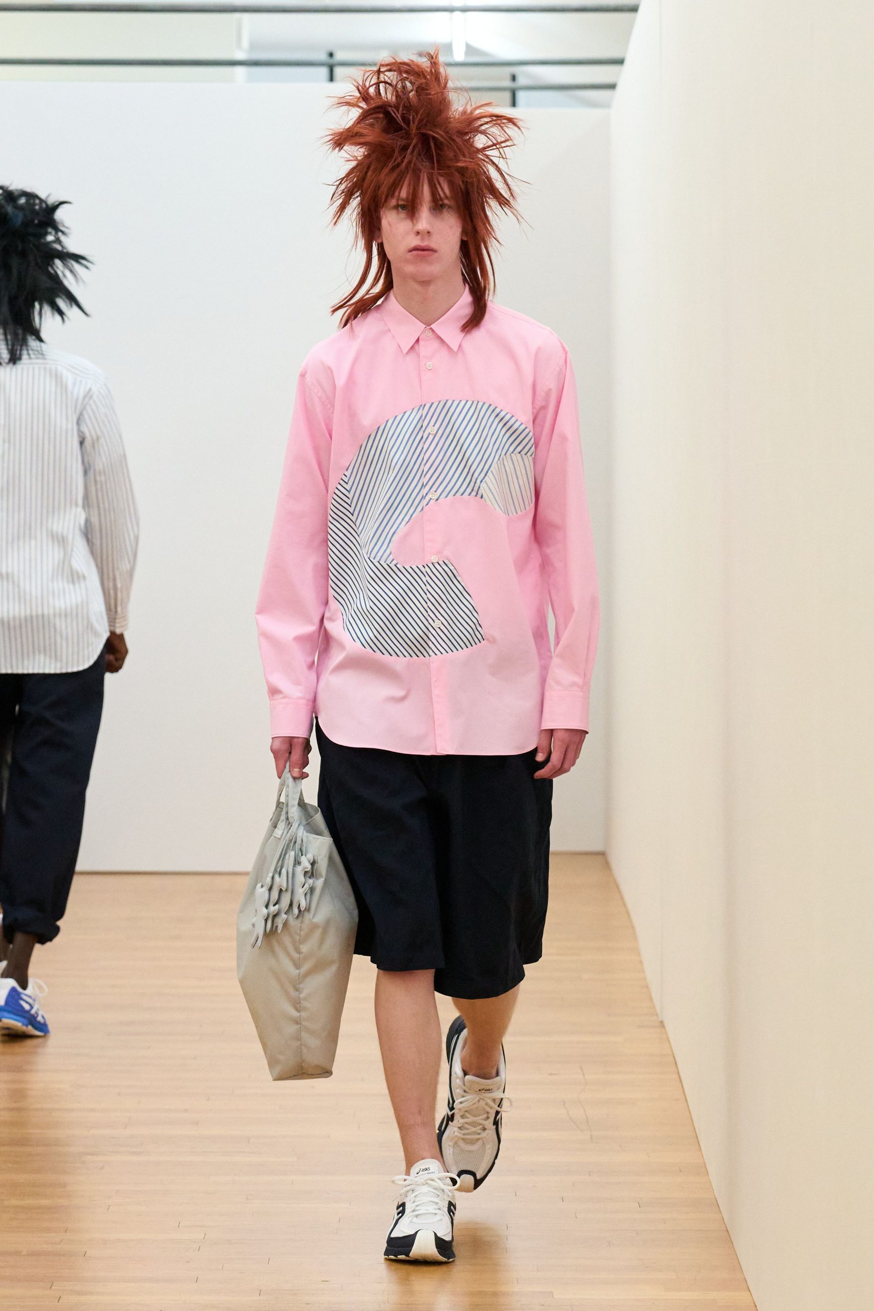 pink collared shirt with black shorts