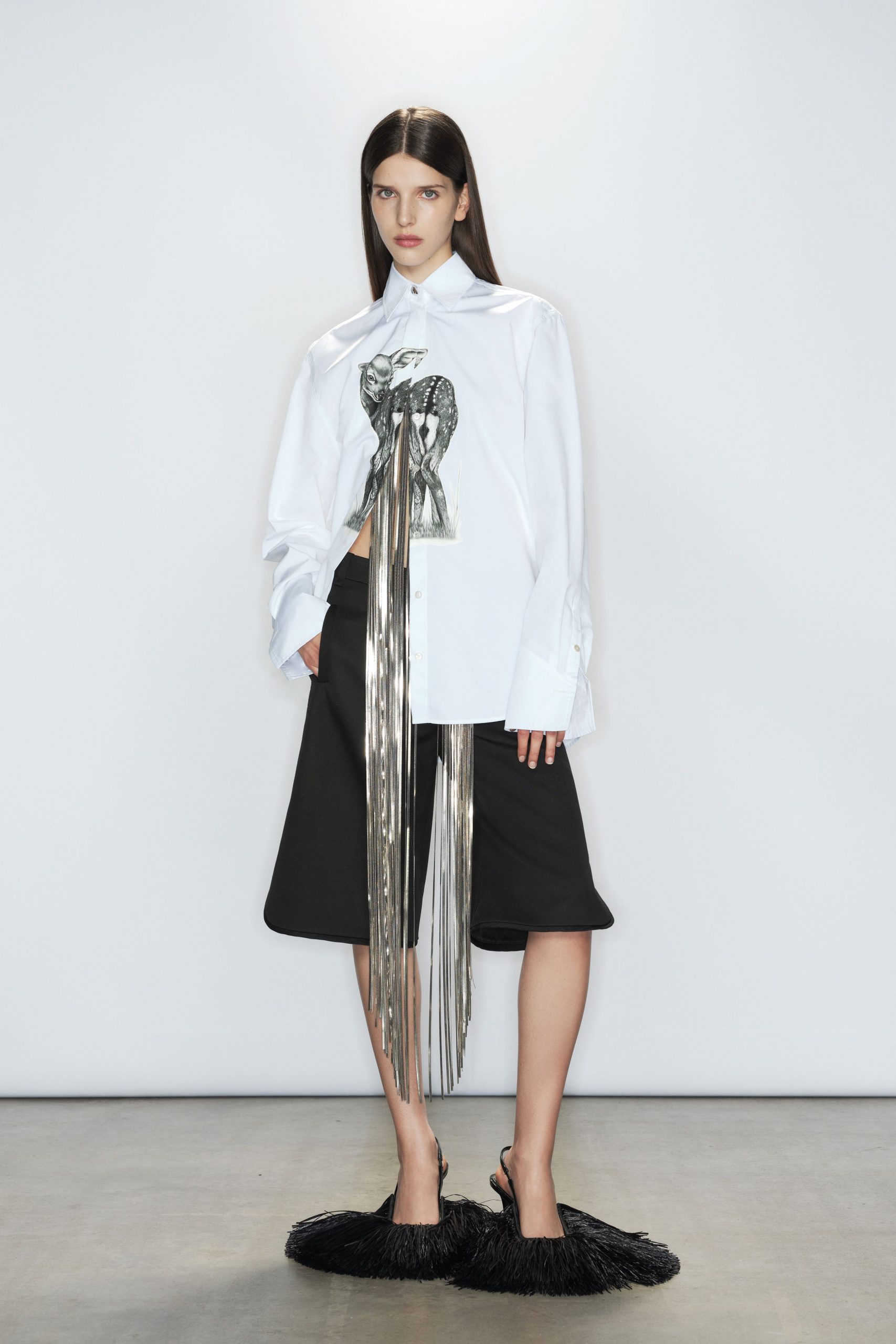 white relaxed shirt with black shorts