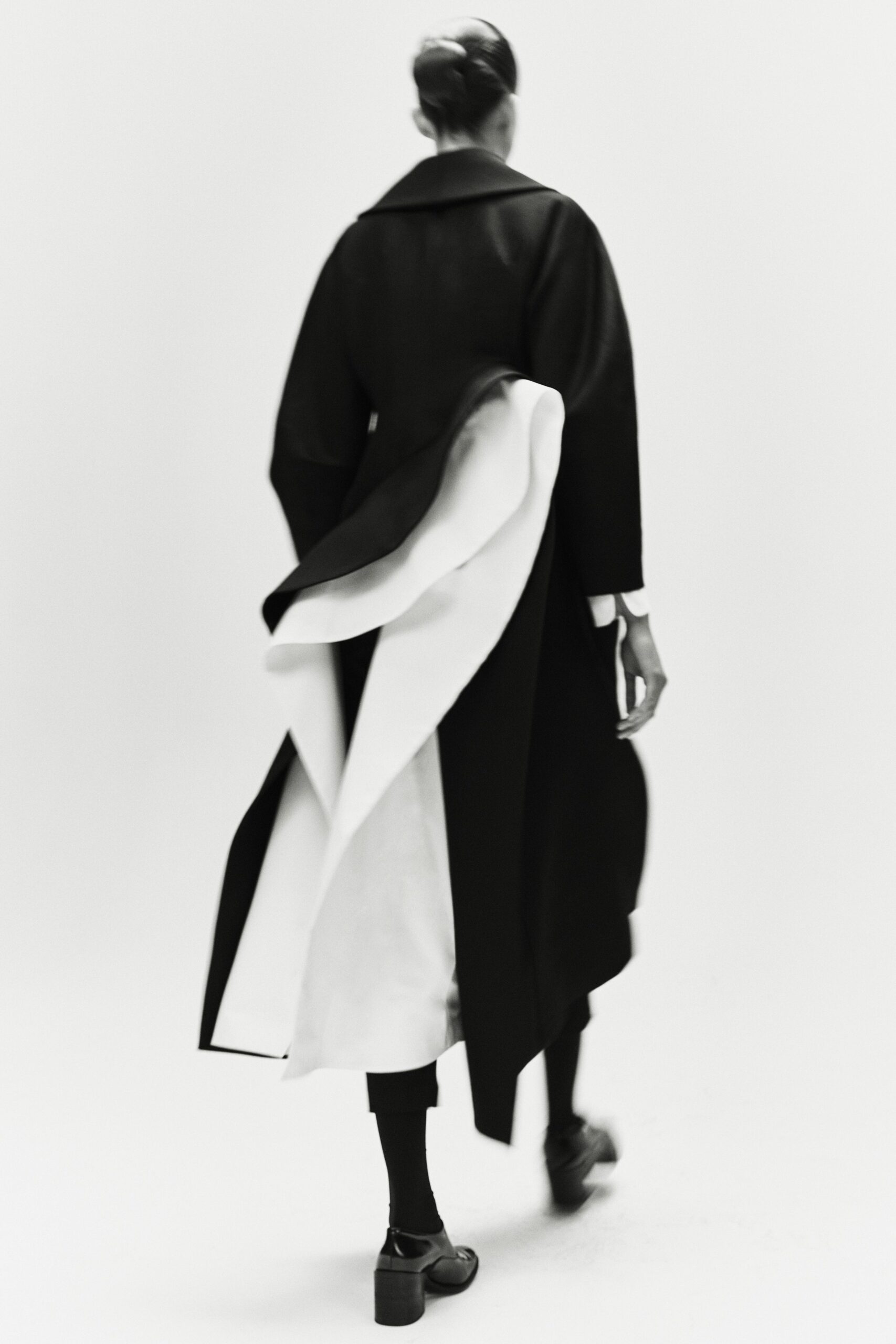 black and white draped coat