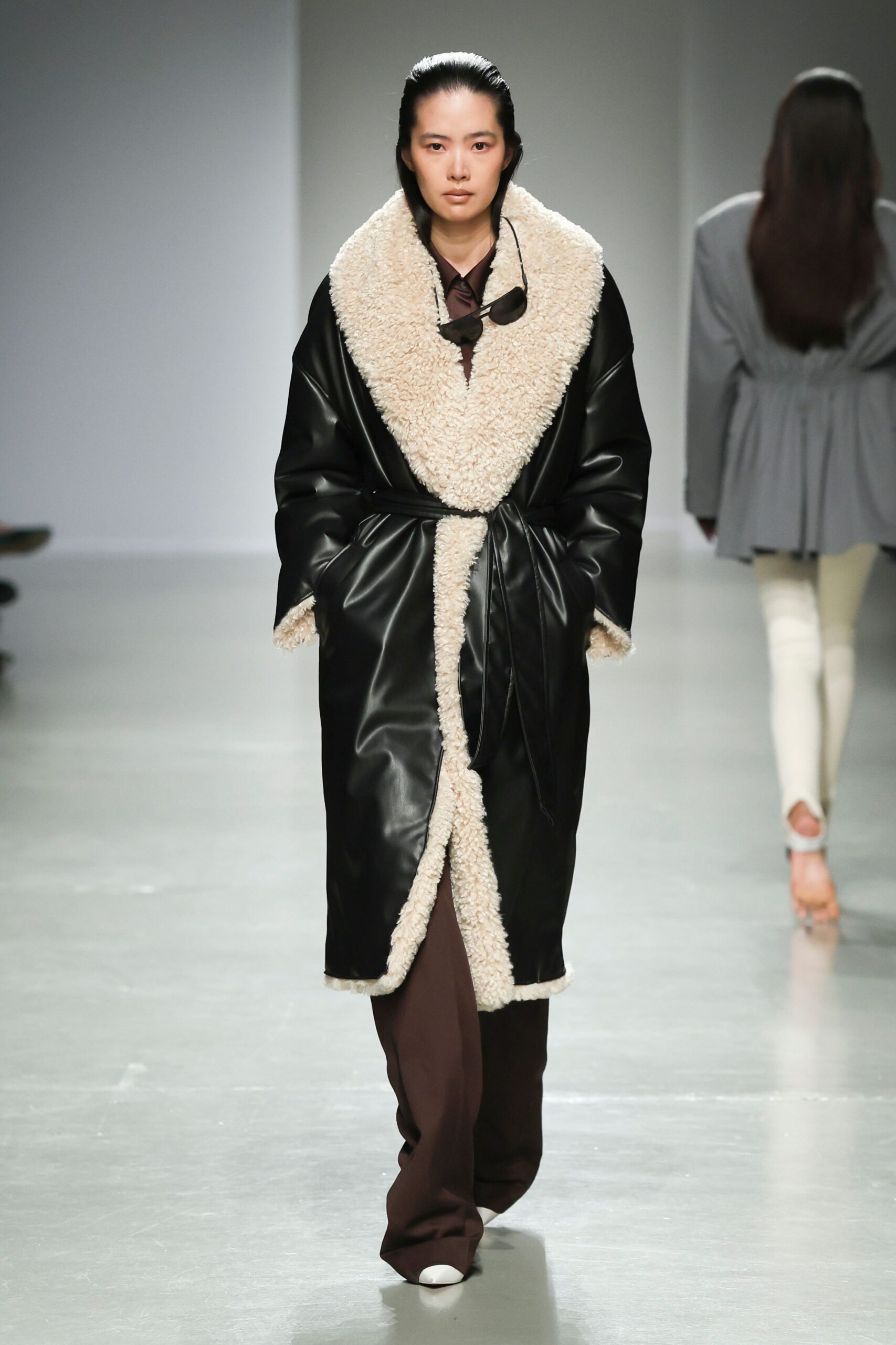 black leather long-sleeve collared relaxed belted coat