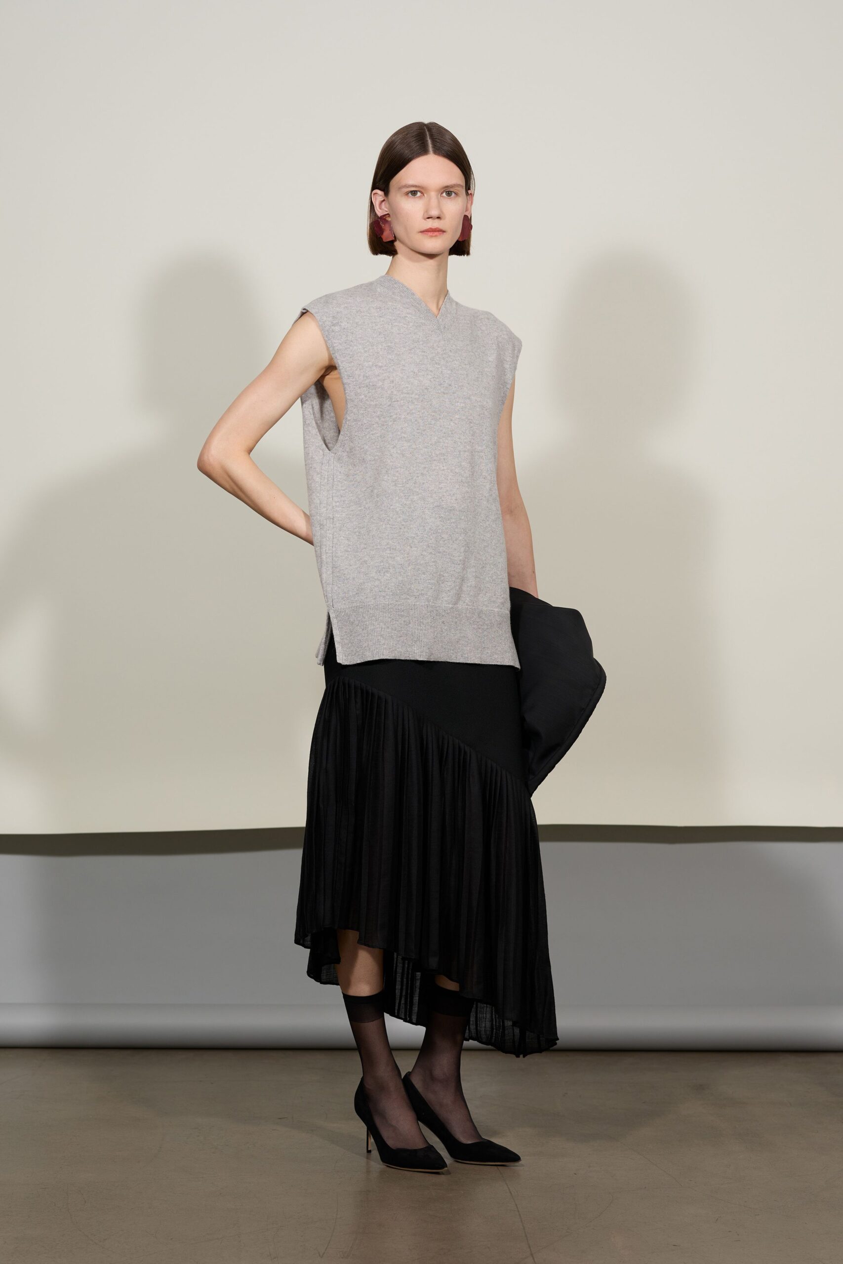 gray sleeveless top with black skirt
