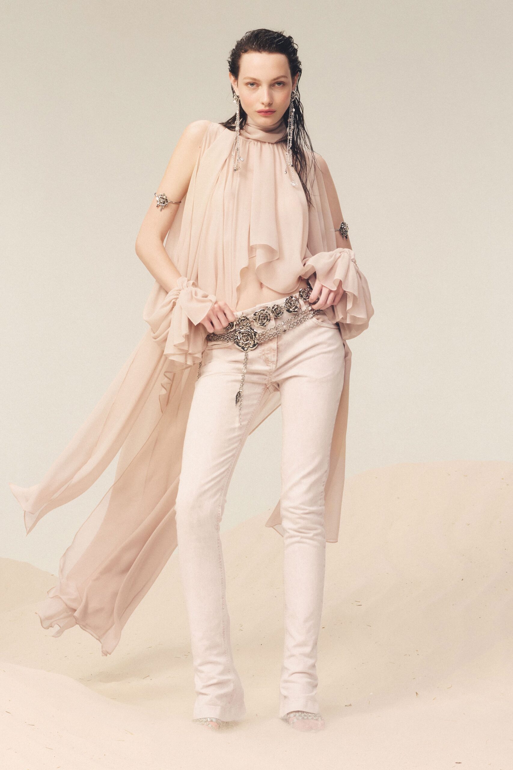 beige ruffled top with white pants