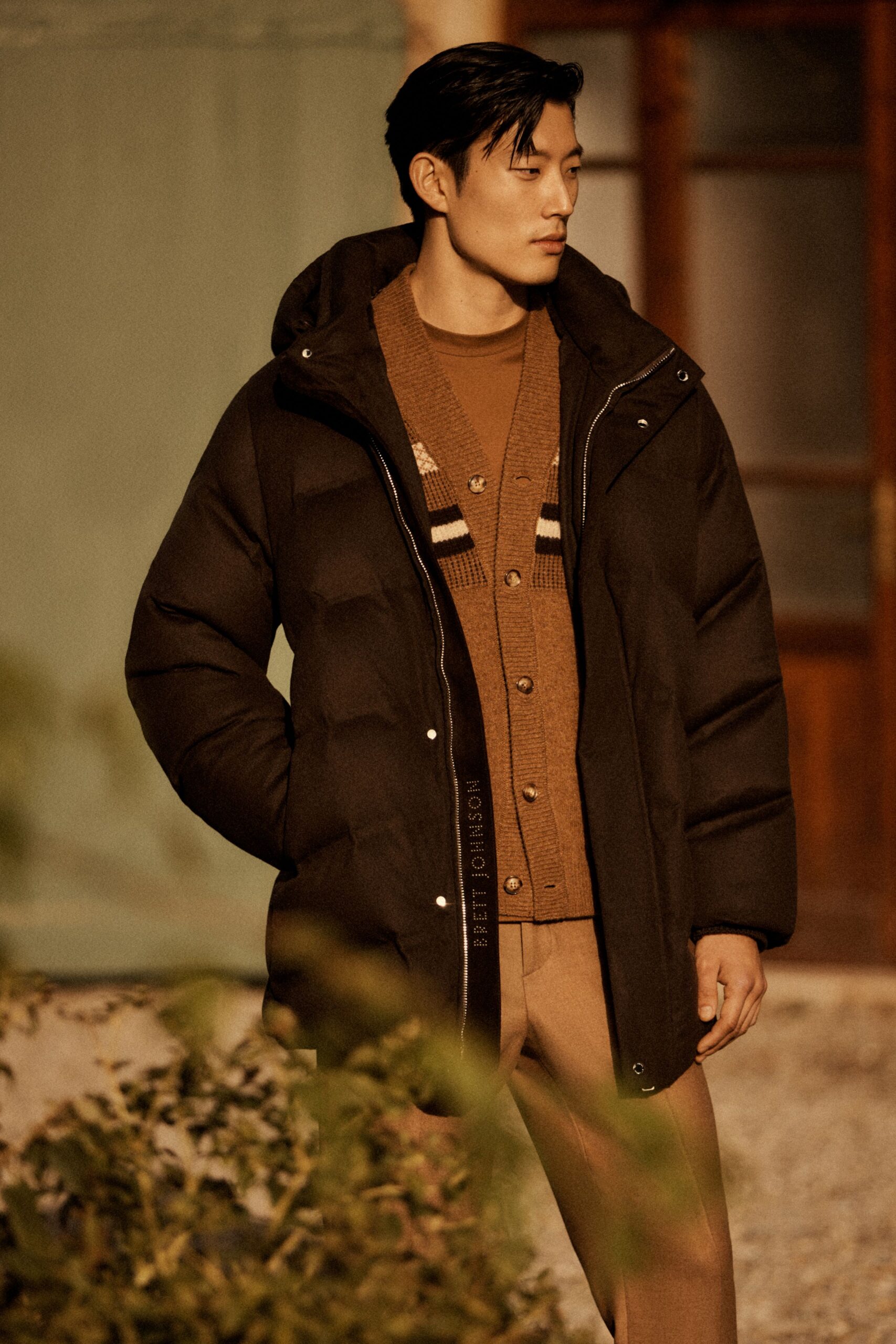 black coat brown sweater beige pants