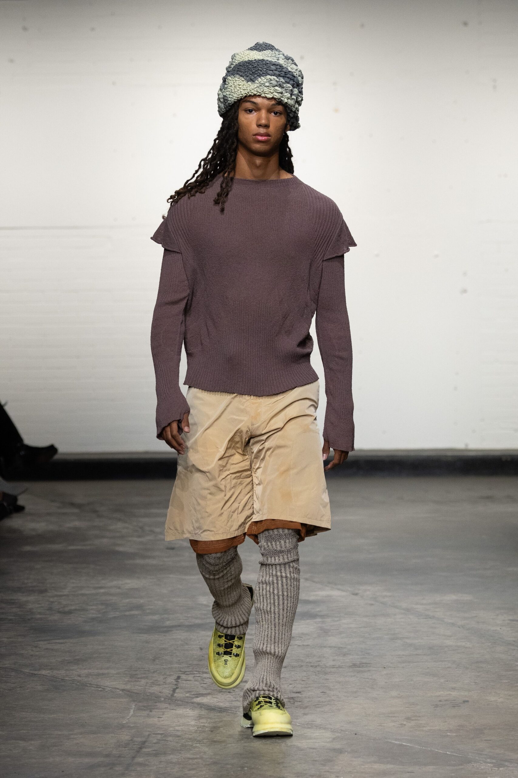purple relaxed sweater with beige shorts