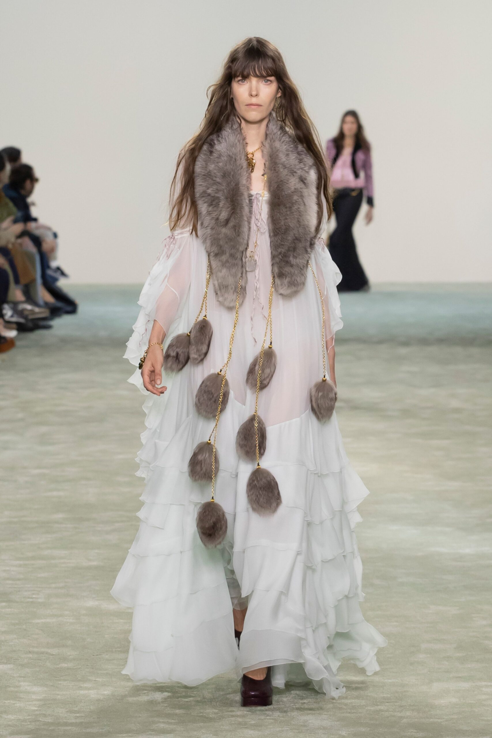 white flowing maxi gown with fur scarf