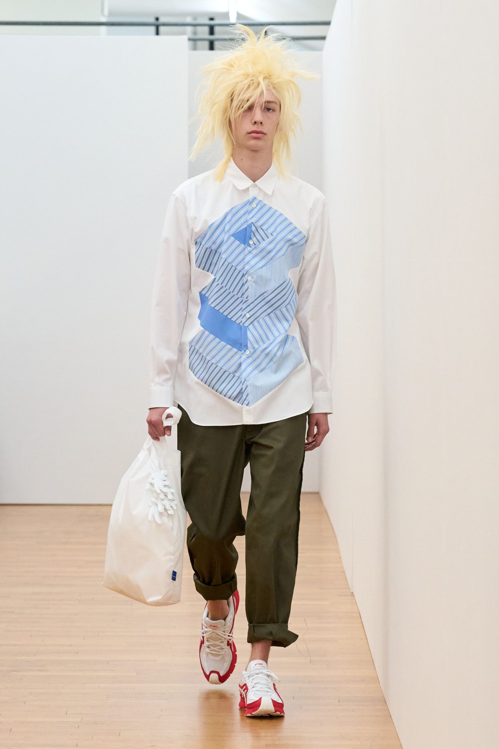 white shirt with blue print and green pants