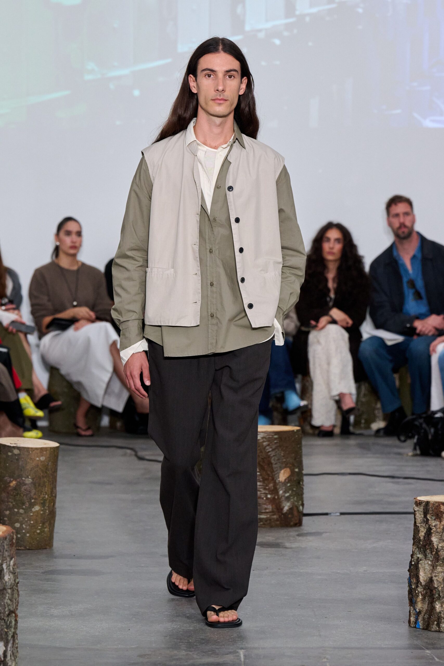 beige jacket green shirt black pants sandals