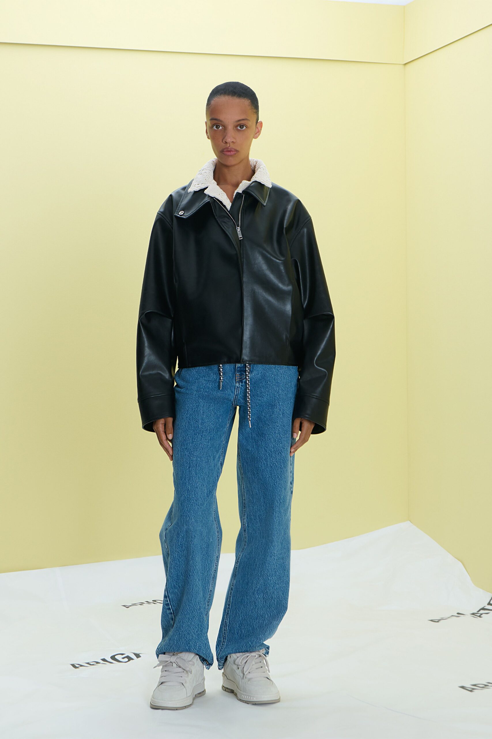 black leather relaxed jacket with blue denim pants